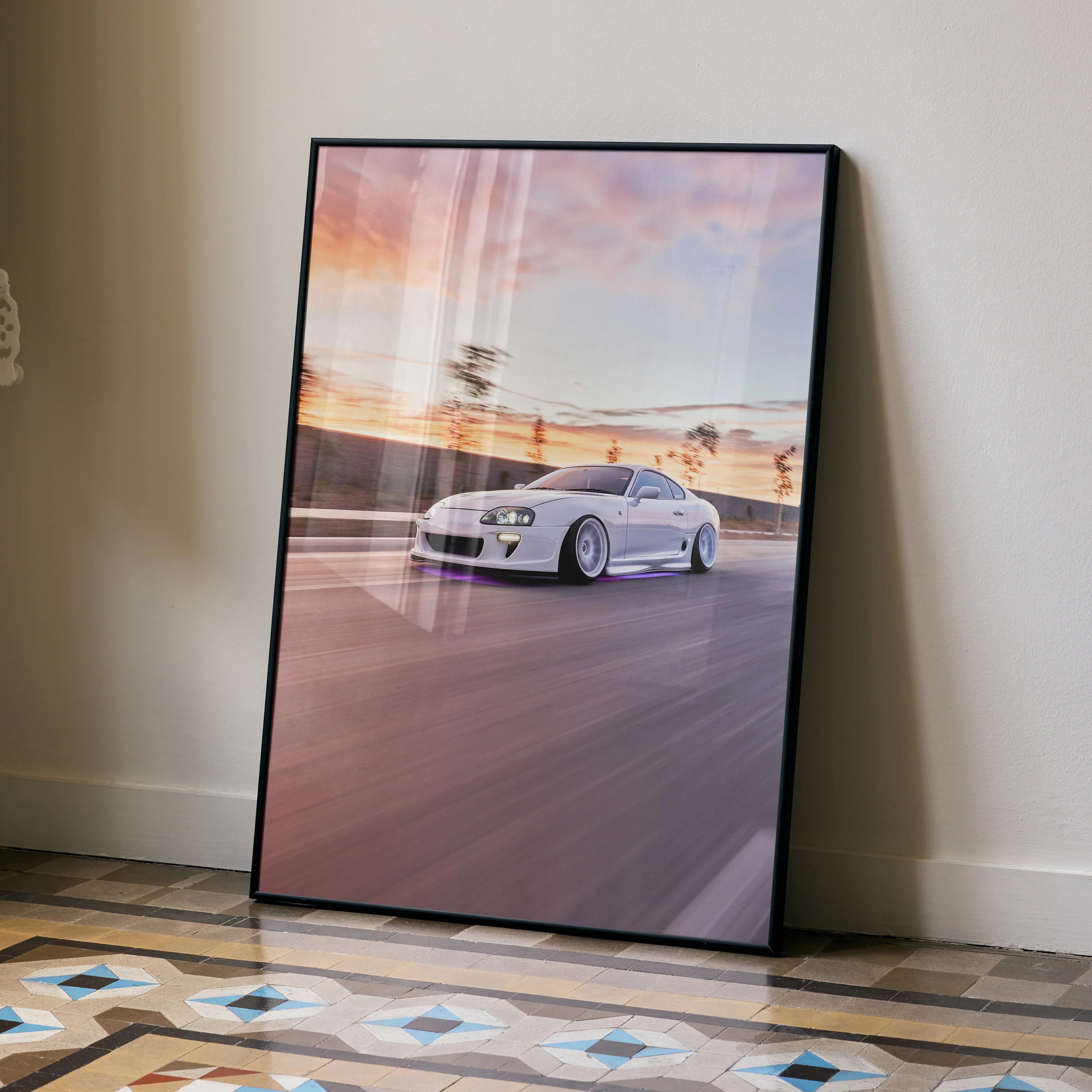 Toyota Supra MK4 poster with white sports car speeding on racetrack at sunset wall art.