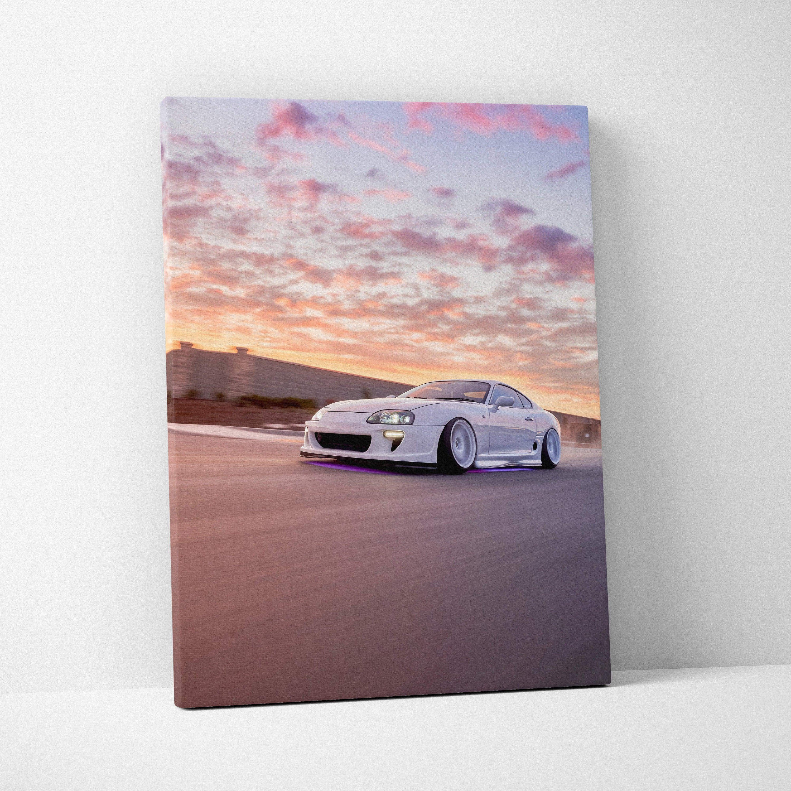 Toyota Supra MK4 driving at sunset on canvas wall art with vibrant sky colors.