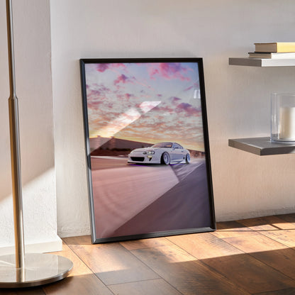 Toyota Supra MK4 poster featuring white sports car on road under vibrant sunset sky, wall art in black frame.