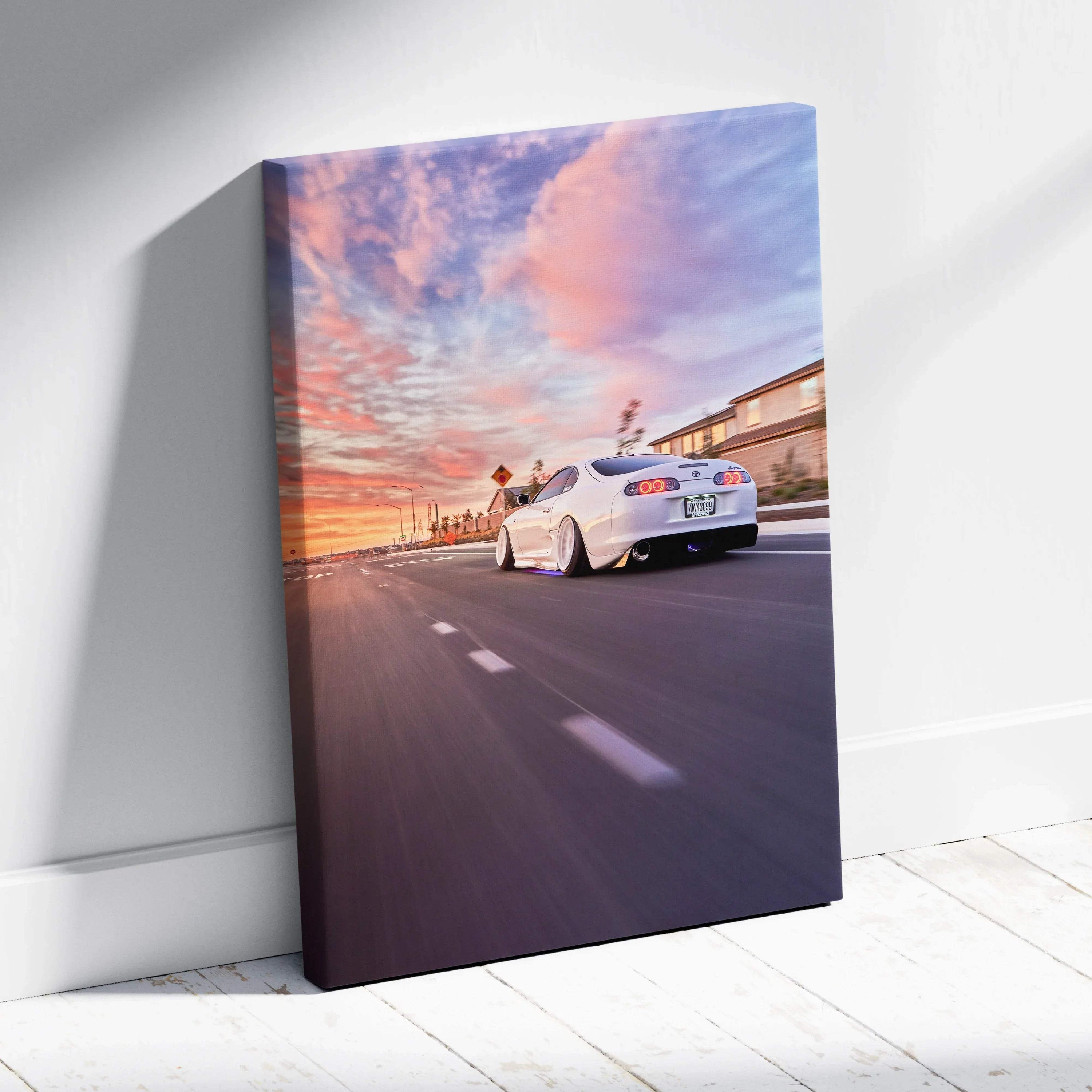 Toyota Supra MK4 driving at sunset with colorful sky on vertical canvas wall art.