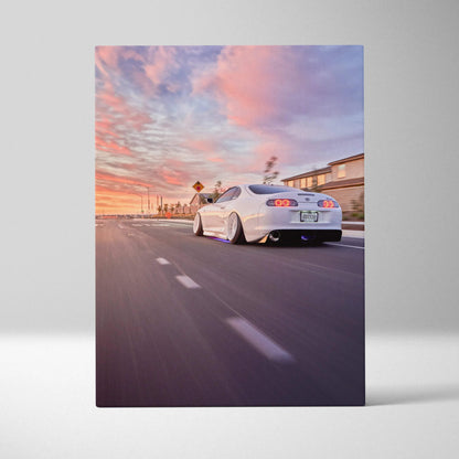 Toyota Supra MK4 in motion at sunset with pink sky, vertical canvas wall art print.