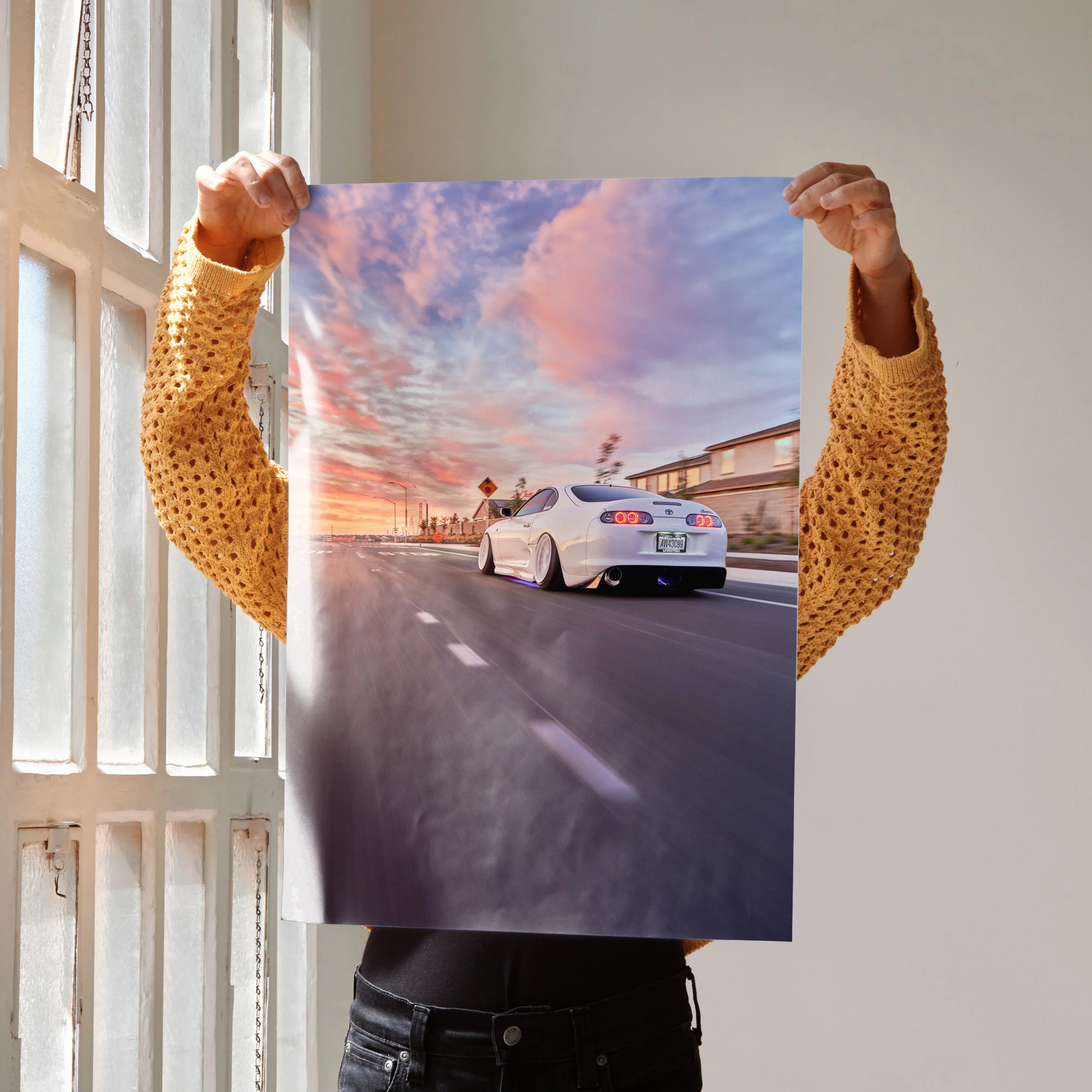 Toyota Supra MK4 driving at sunset with vibrant sky, high-resolution poster wall art.