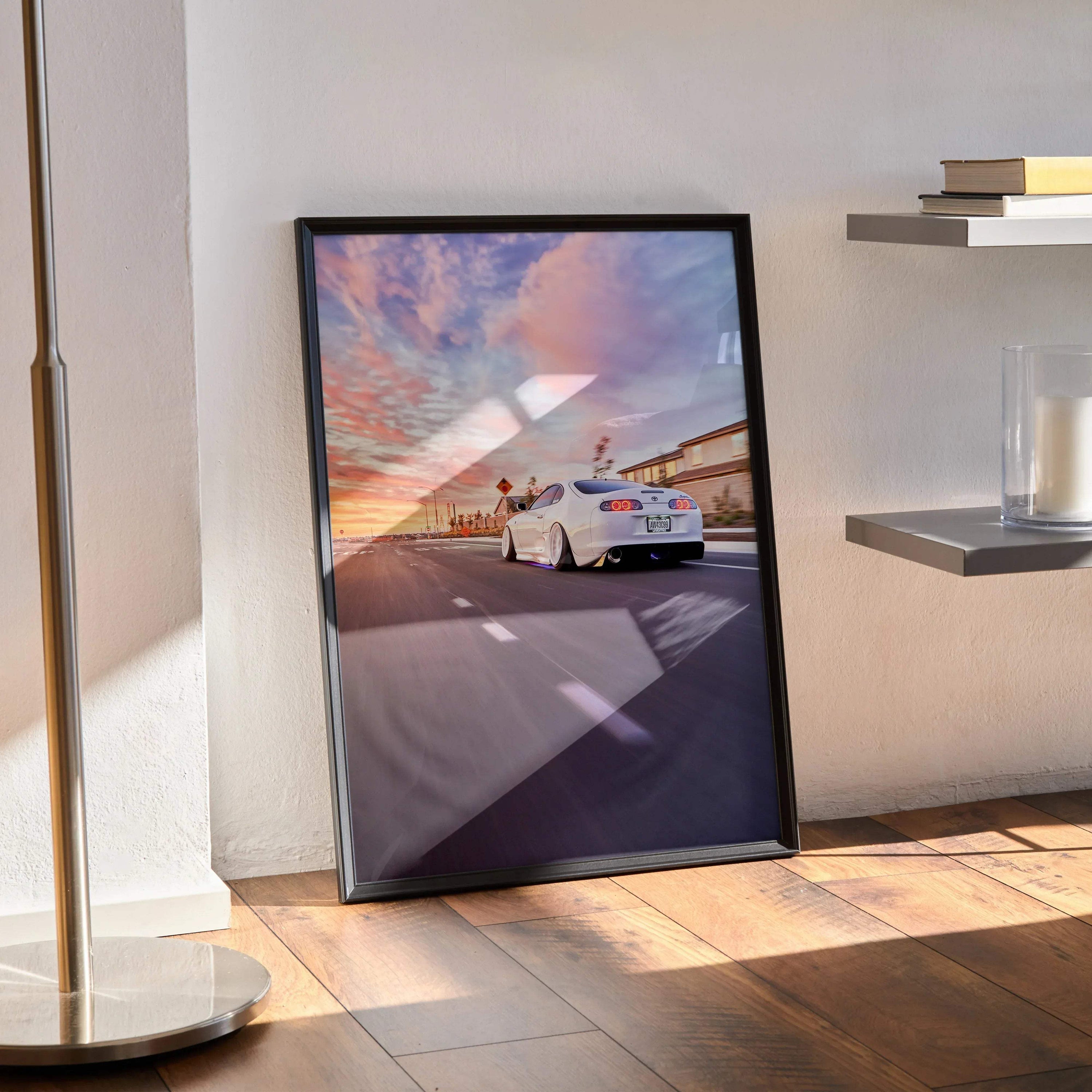 Toyota Supra MK4 poster featuring sunset street scene, sleek white sports car wall art in black frame.