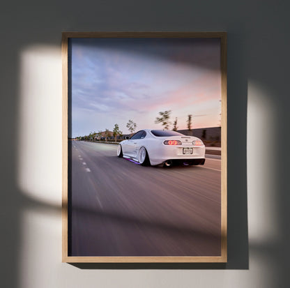 Toyota Supra MK4 in white driving on highway at sunset poster wall art.