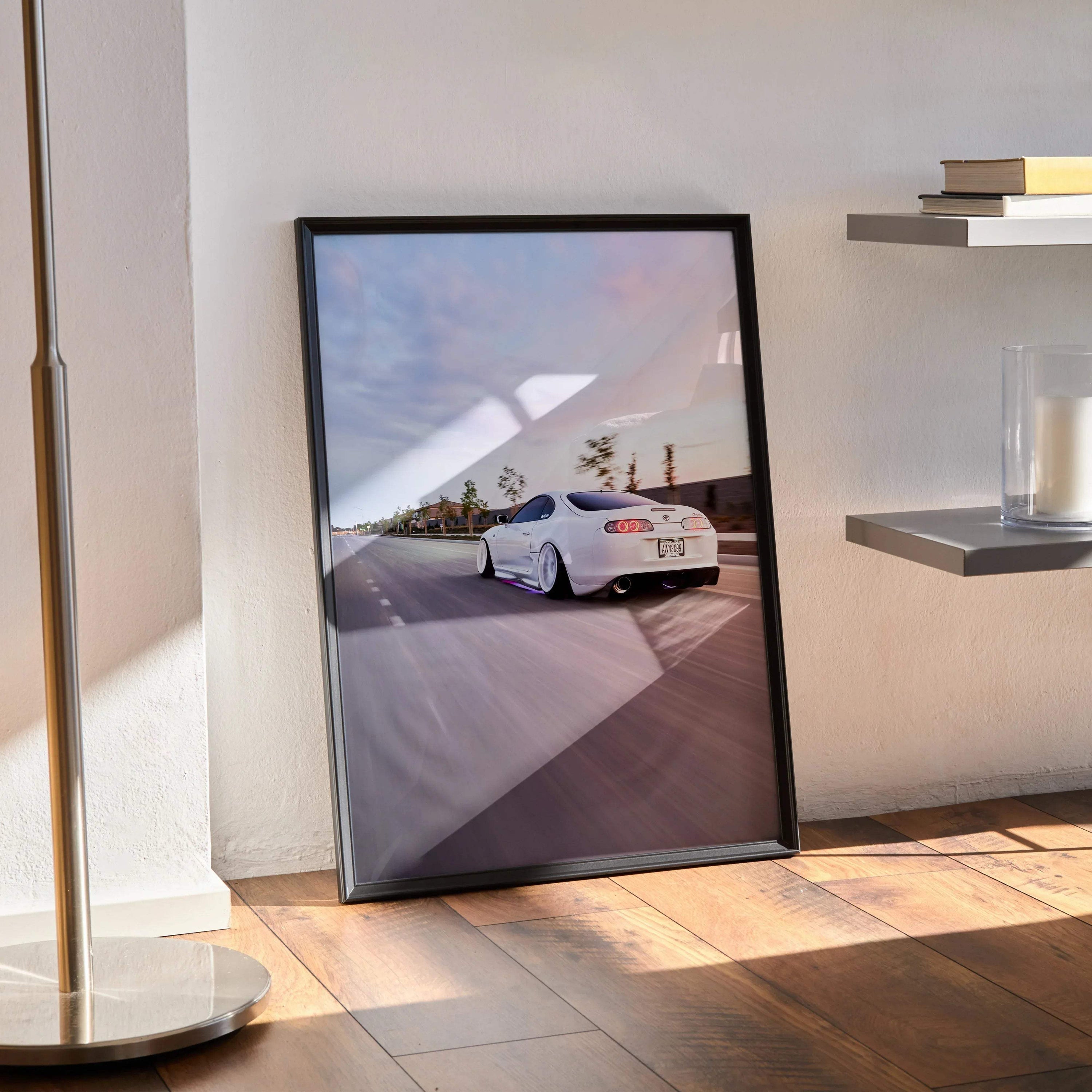 Supreme Toyota Supra MK4 white sports car poster in black frame on floor wall art.
