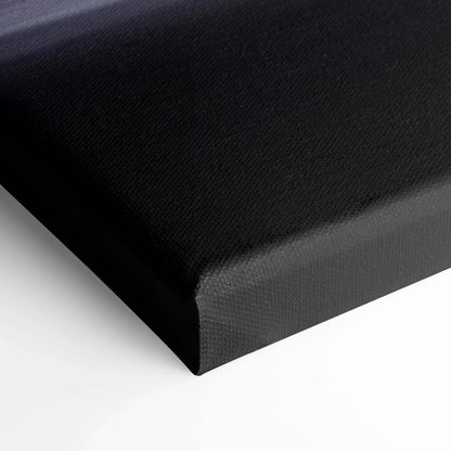 Close-up of black textured canvas wall art corner with thick white inner frame edge.