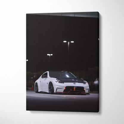 White Nissan 370z sports car at night with streetlights, vertical canvas wall art.