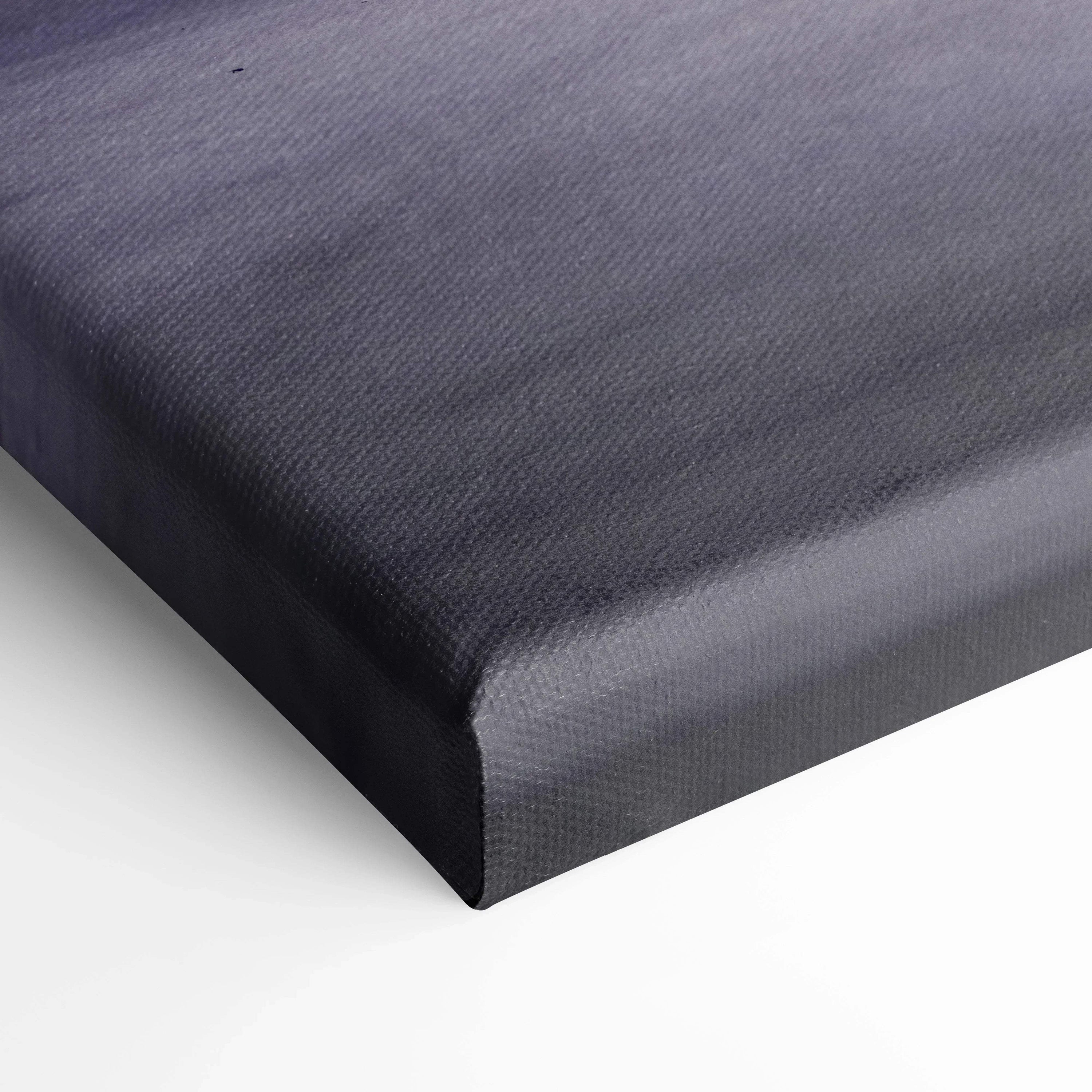 Close-up of black textured canvas wall art corner with visible woven fabric pattern and wrapped edges.