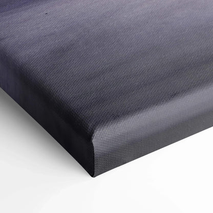 Close-up of black textured canvas wall art corner with visible woven fabric pattern and wrapped edges.