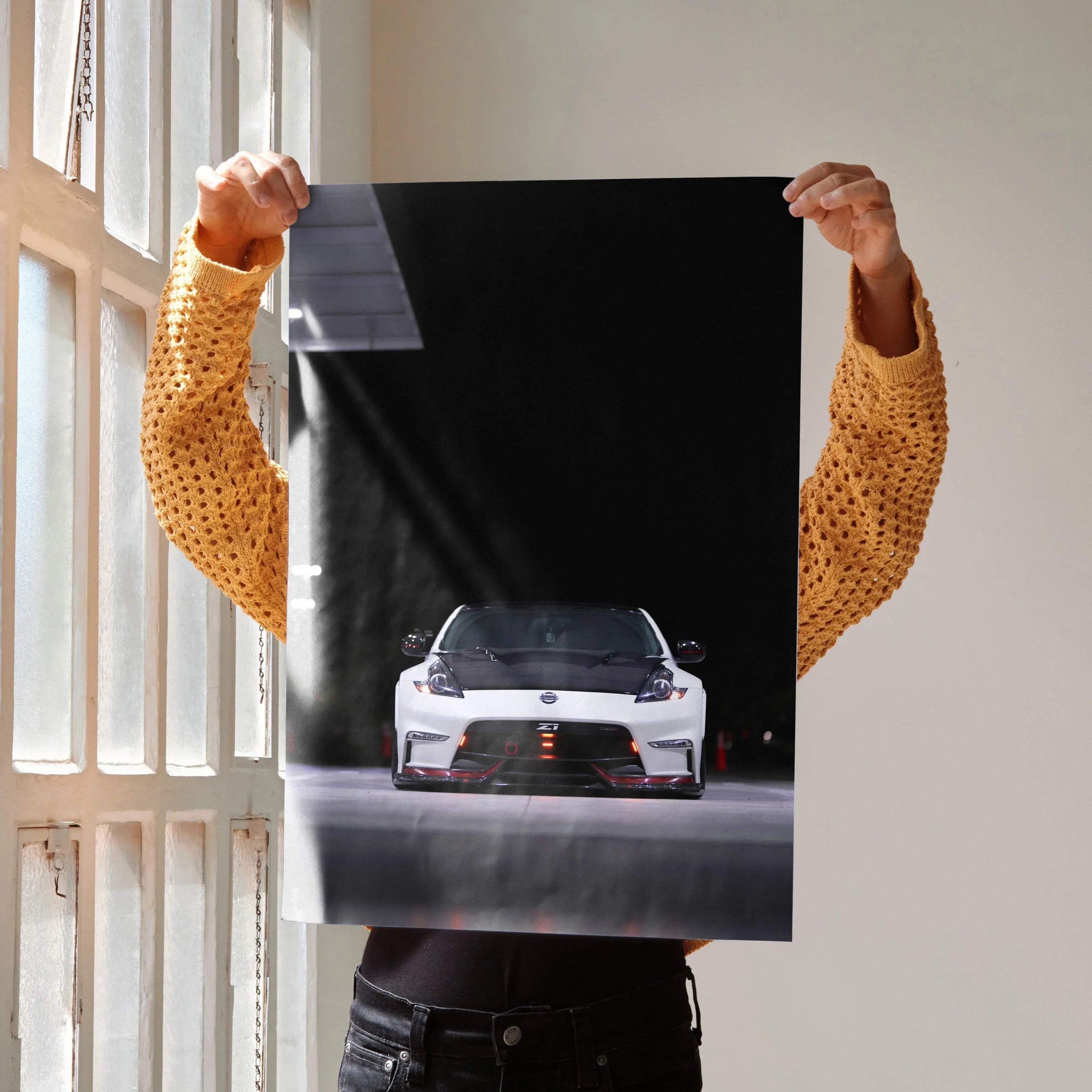 Nissan 370z poster featuring front view of white sports car on black background wall art.