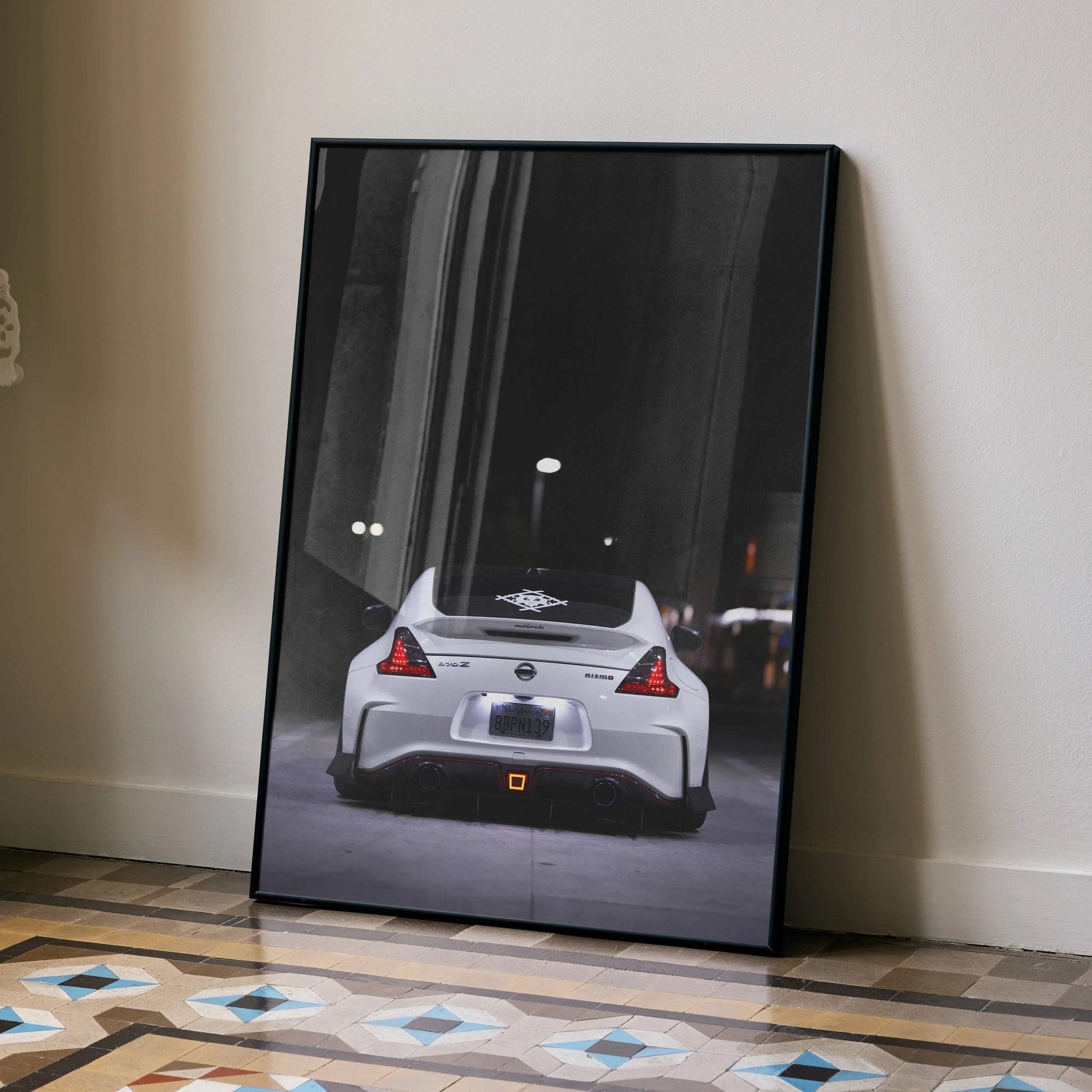 Nissan 370z rear view poster wall art with sleek white sports car on city street at night.
