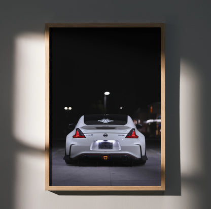 Nissan 370z rear view at night poster wall art with sleek white sports car and dark background.