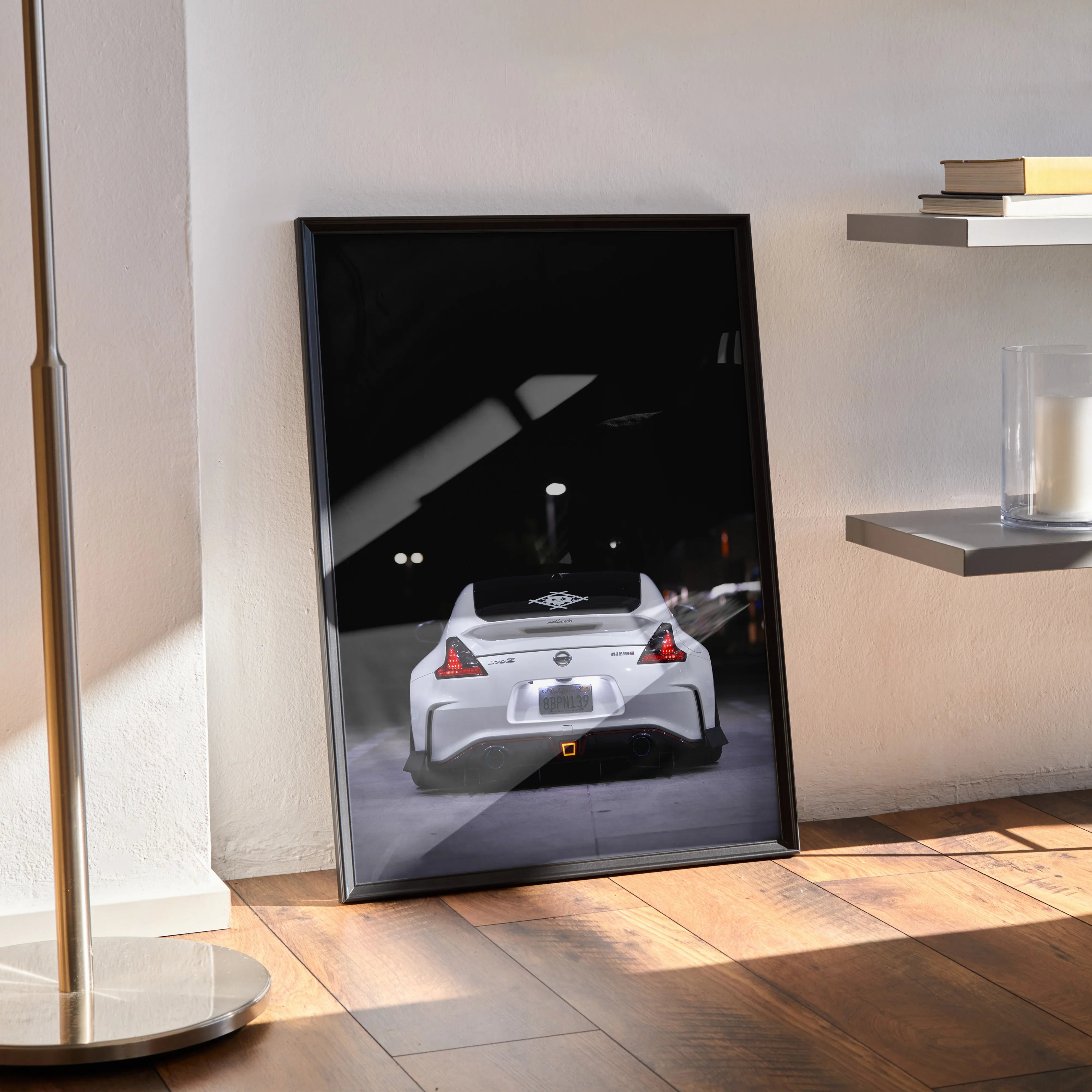 Nissan 370z rear view poster wall art with sleek white sports car on black background.