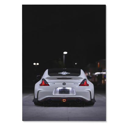 White Nissan 370z rear view at night poster wall art with lit taillights and dark background.