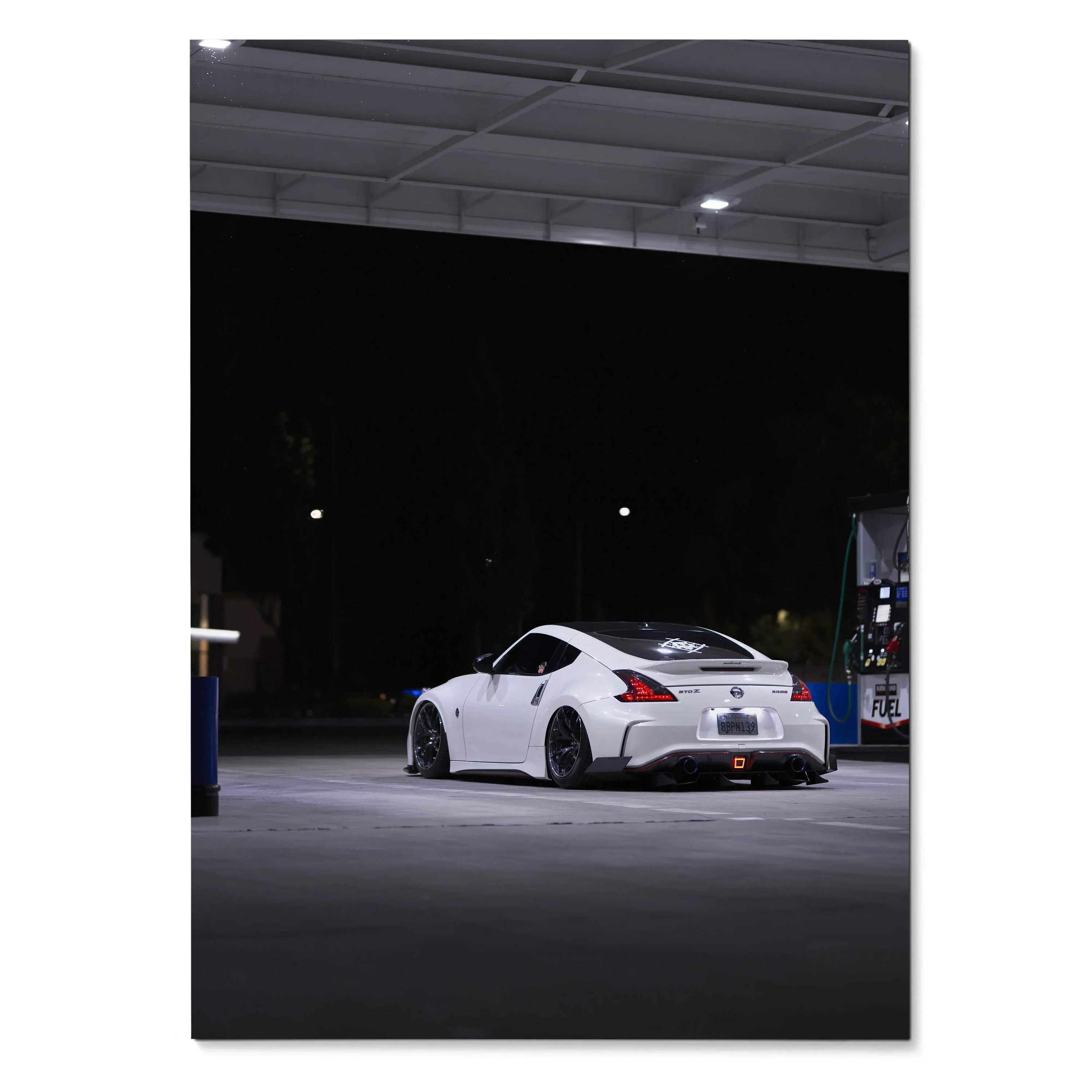 White Nissan Z34 370z parked under gas station lights at night poster wall art.
