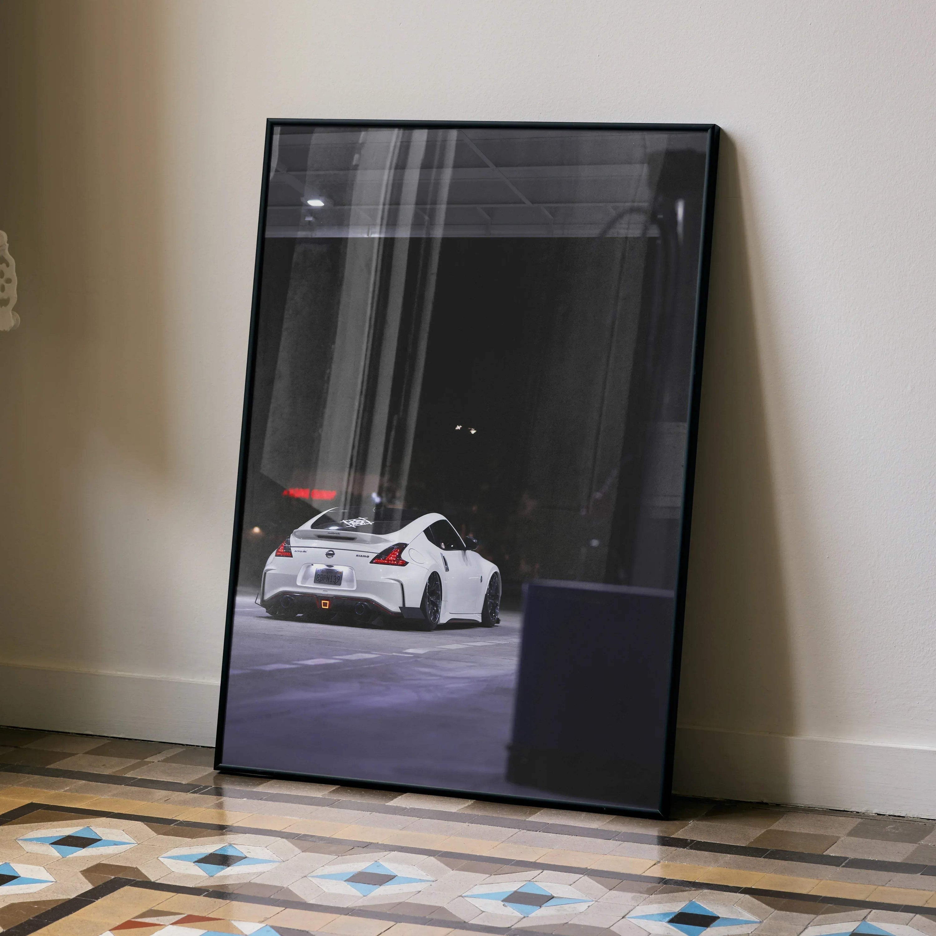 Nissan 370z white car rear view poster in black frame leaning against wall wall art.
