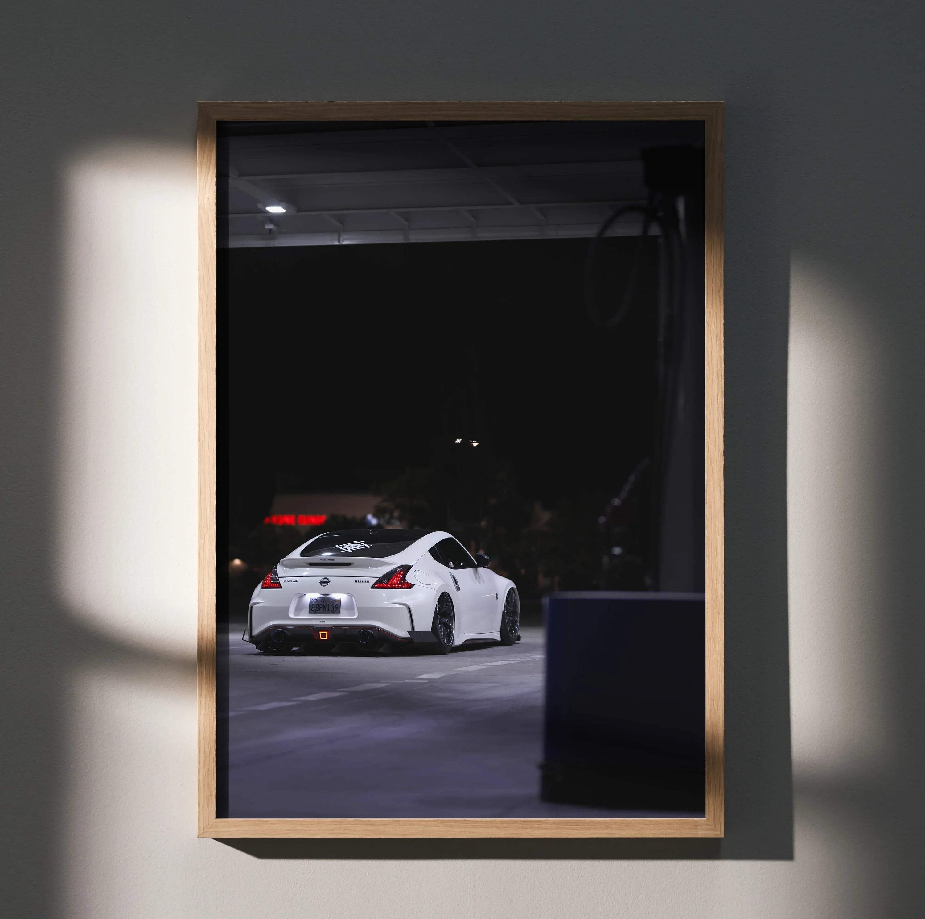 Nissan 370z white sports car night scene poster framed wall art in wooden frame.