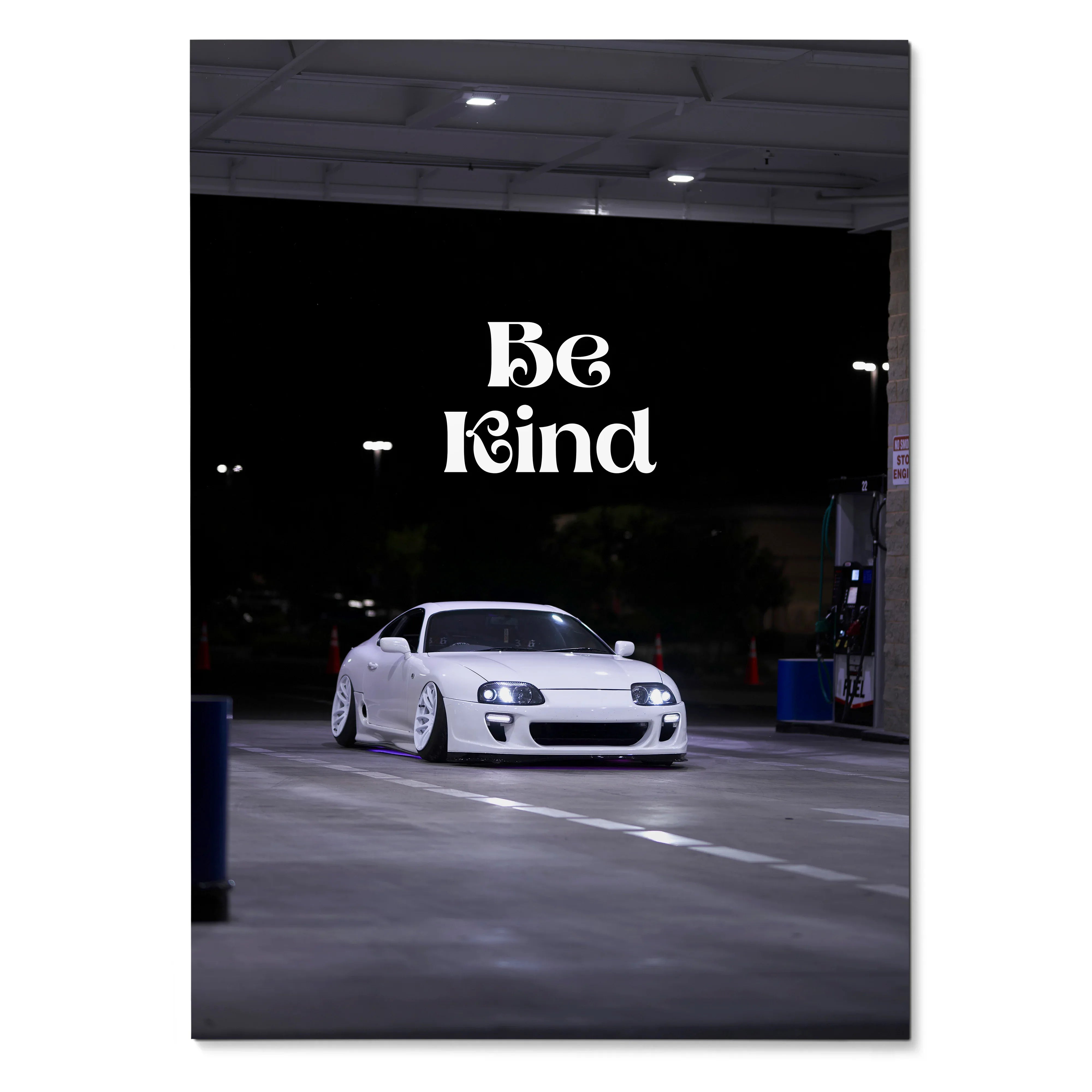 White Toyota Supra Mk4 parked at night with "Be Kind" text, motivational poster wall art.