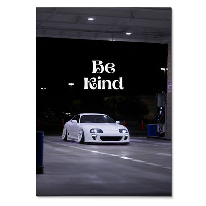 White Toyota Supra Mk4 parked at night with "Be Kind" text, motivational poster wall art.