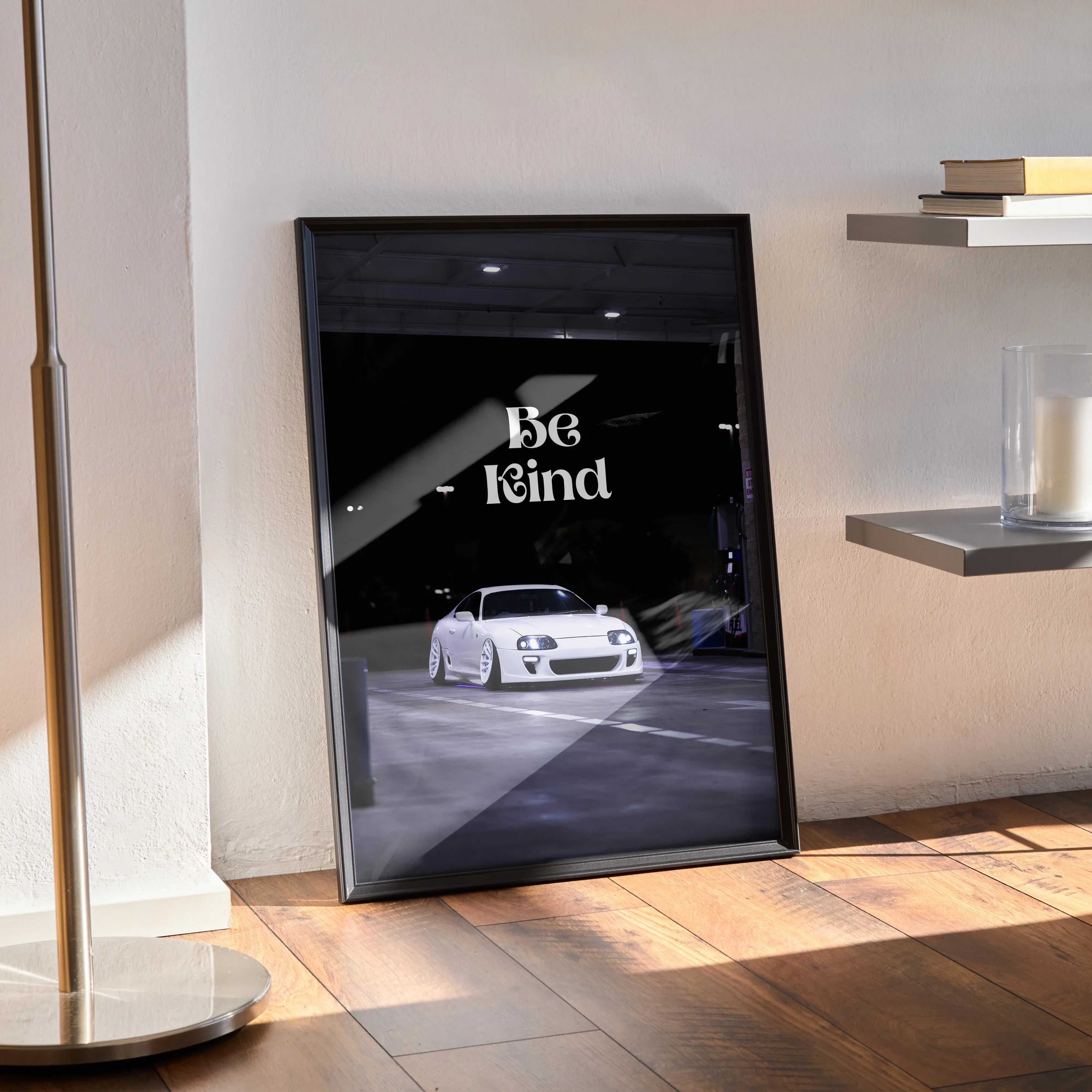 Motivational poster wall art with white Toyota Supra Mk4 and "Be Kind" text in black frame.