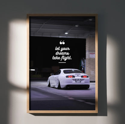 Motivational wall art poster featuring a white Toyota Supra Mk4 with inspiring text "Let your dreams take flight" against a.