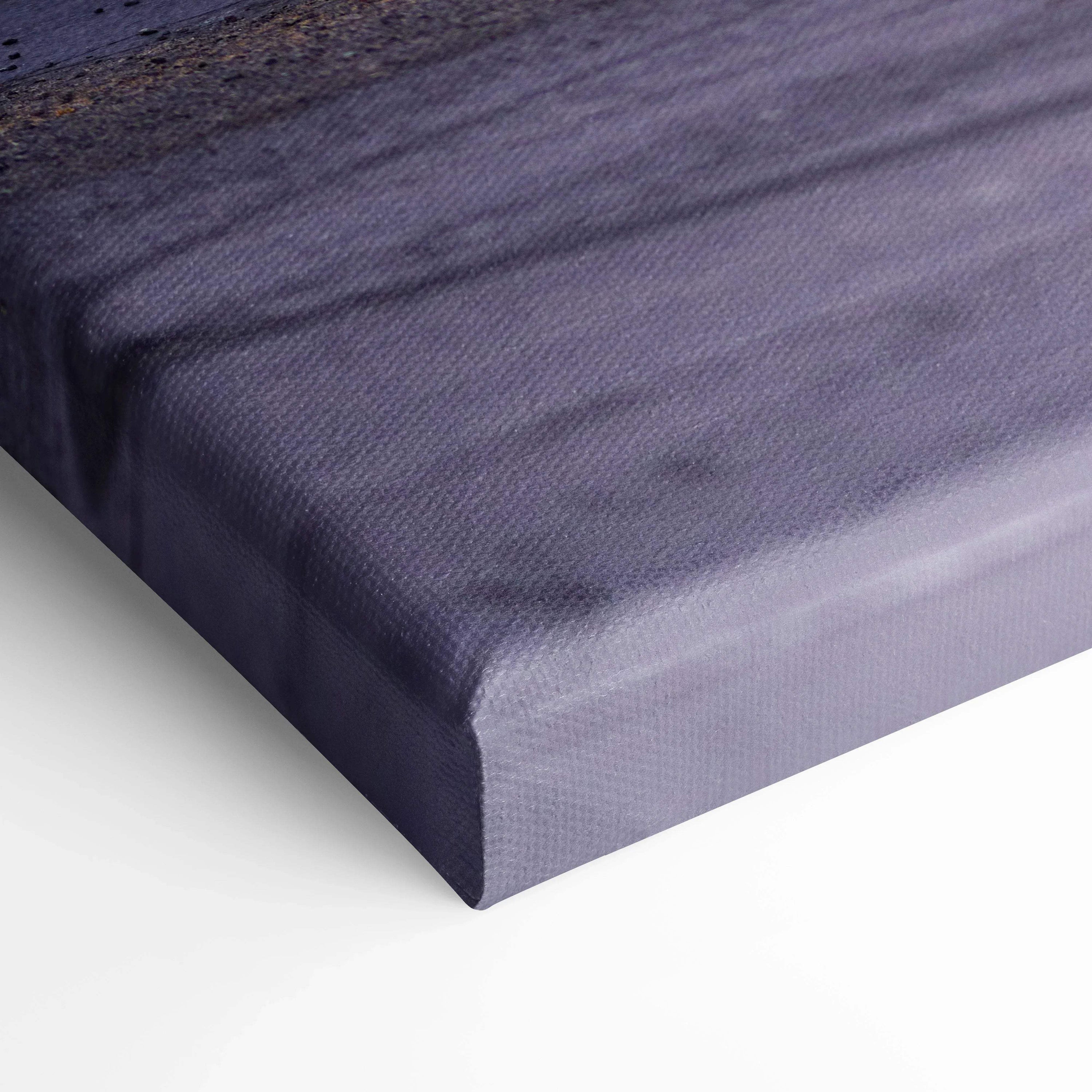 Close-up of textured edge on vertical Nissan 240z canvas wall art in muted blue tones.
