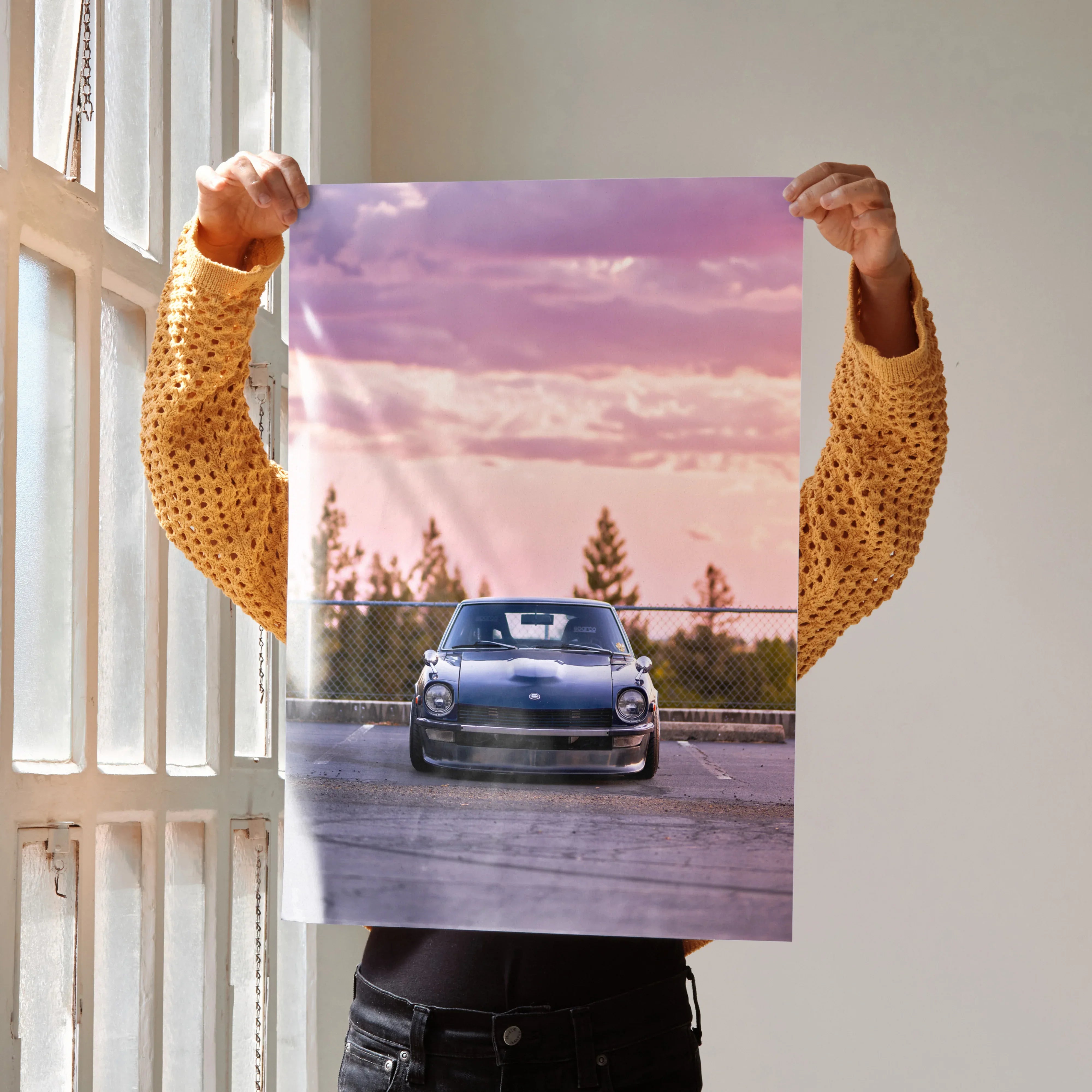 Nissan 240z poster wall art with sunset sky and silhouette background in vibrant colors.