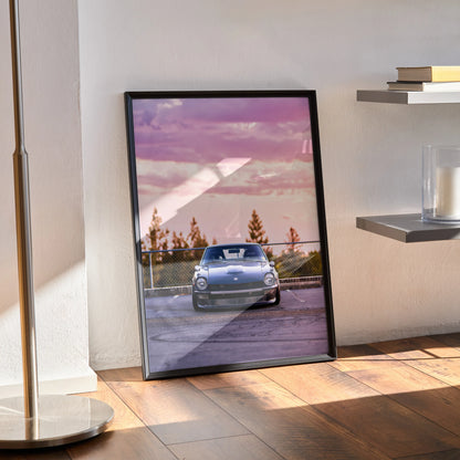 Nissan 240z poster with sunset sky and trees, modern wall art in black frame.