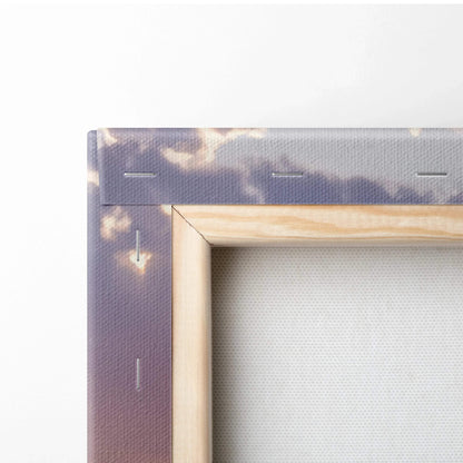 Close-up of wooden frame and textured canvas showing sunset sky on vertical wall art canvas print.