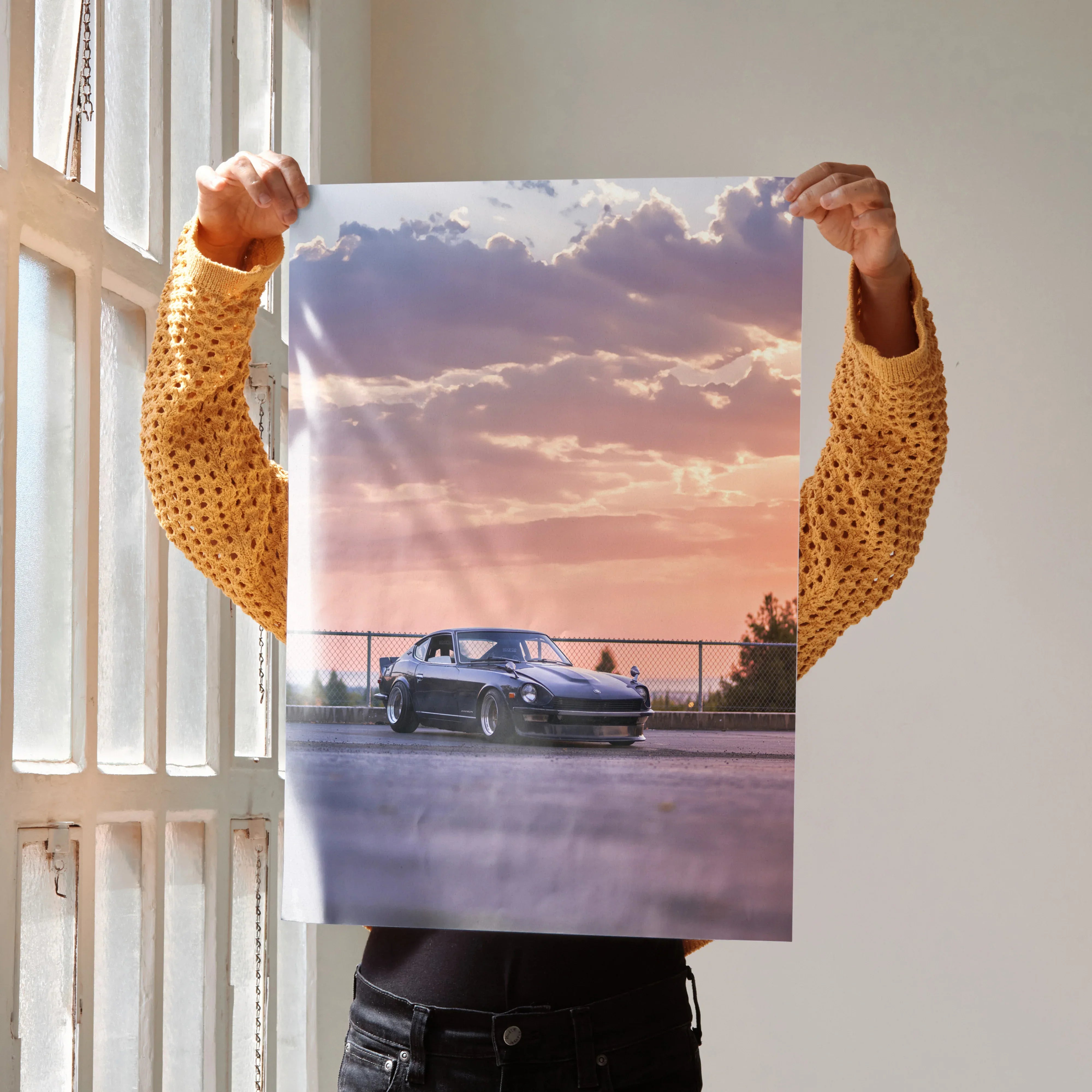 Nissan 240z car driving at sunset high resolution poster wall art with purple and orange sky.