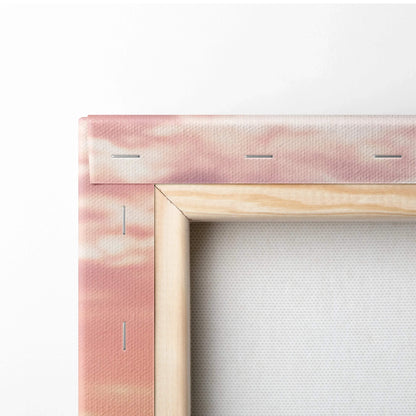 Close-up of raw wood frame and pink fabric stretched canvas wall art corner with visible staples.