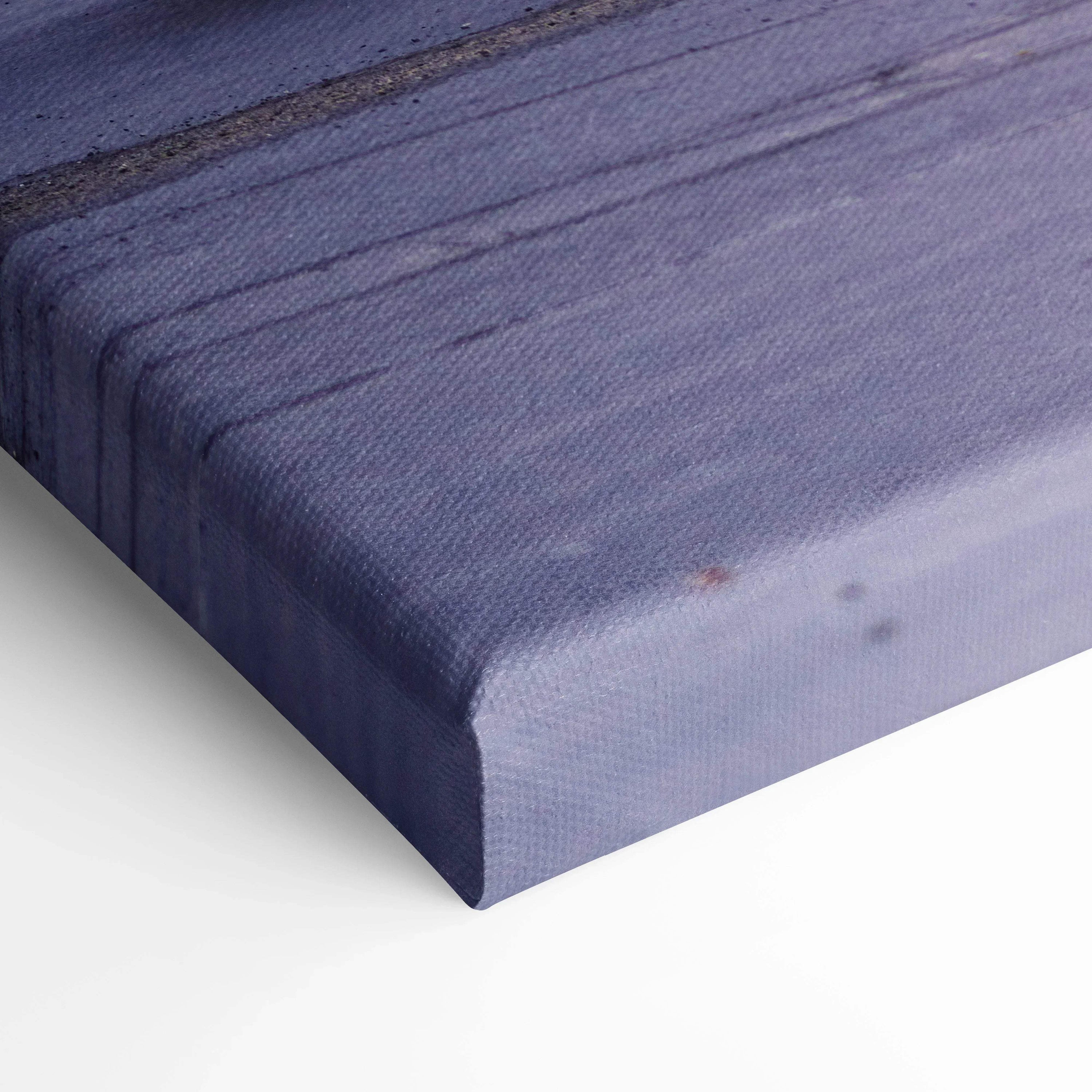 Close-up of Nissan 240z canvas art with textured fabric and wrapped edges in muted blue tones.