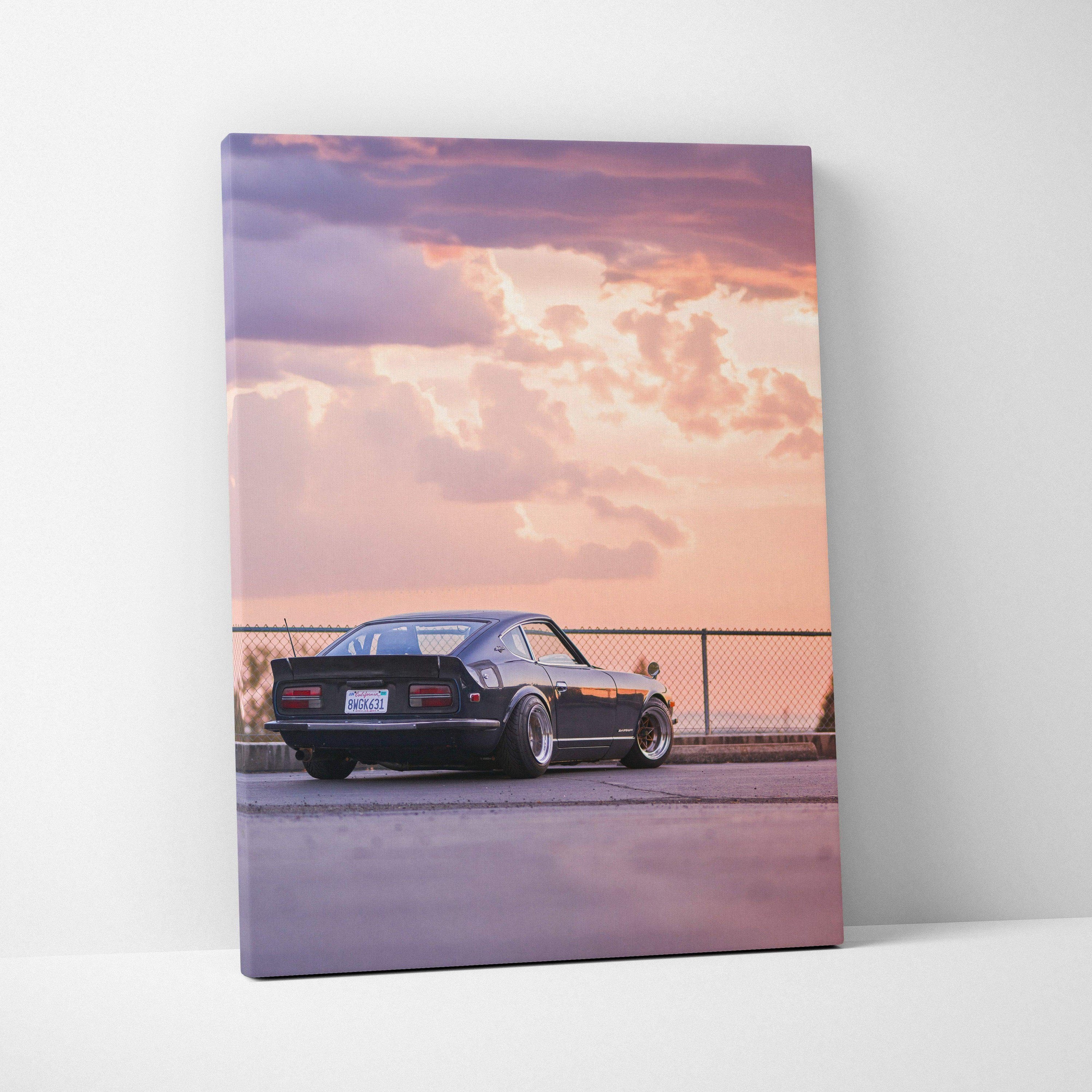 Nissan 240z parked under a vibrant sunset sky on vertical canvas wall art.