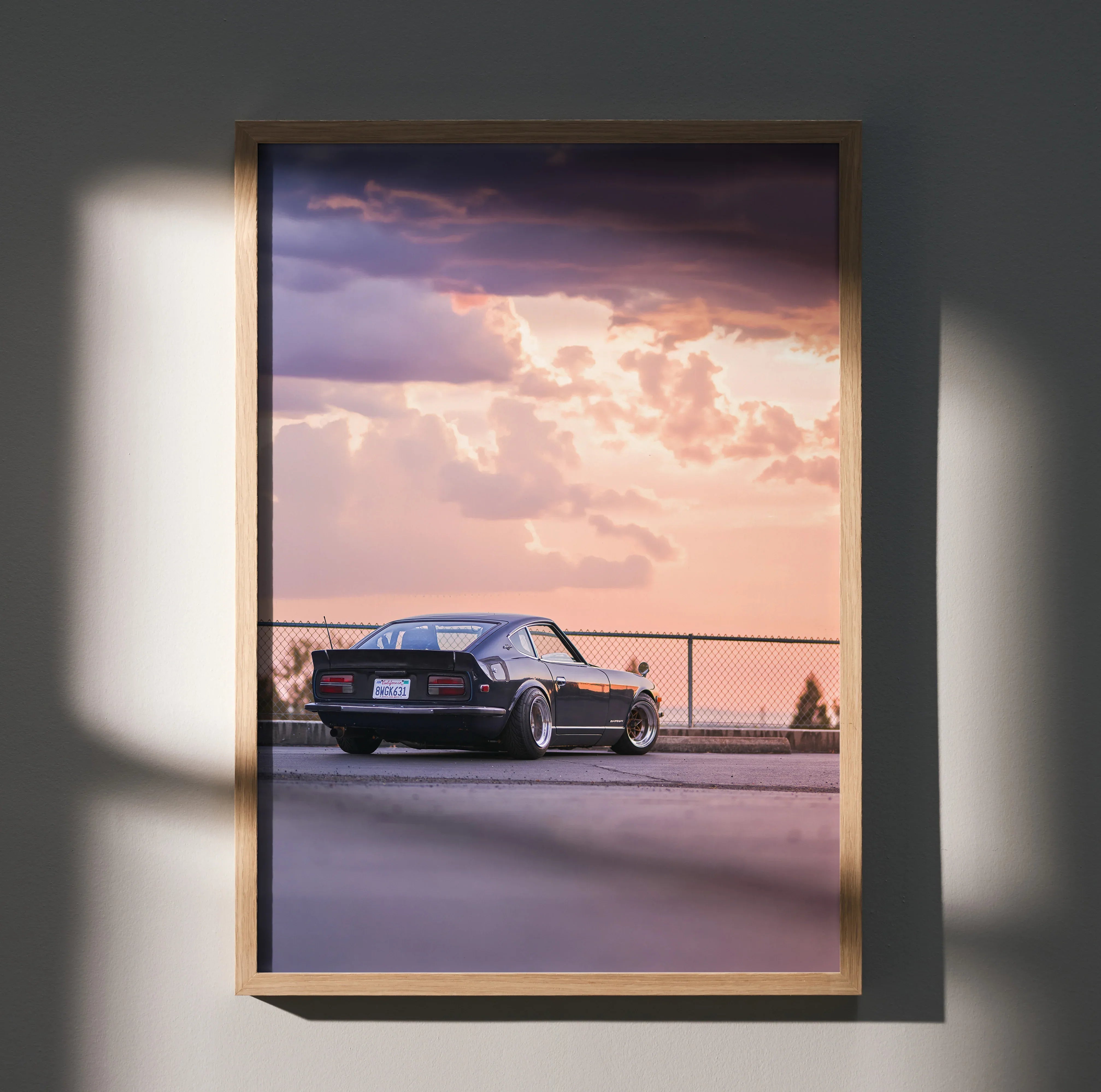 Nissan 240z parked at sunset with dramatic clouds, vintage car wall art poster.