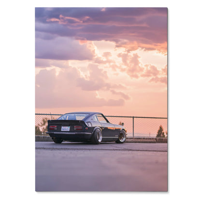 Nissan 240z poster wall art with classic car against a vibrant sunset sky.