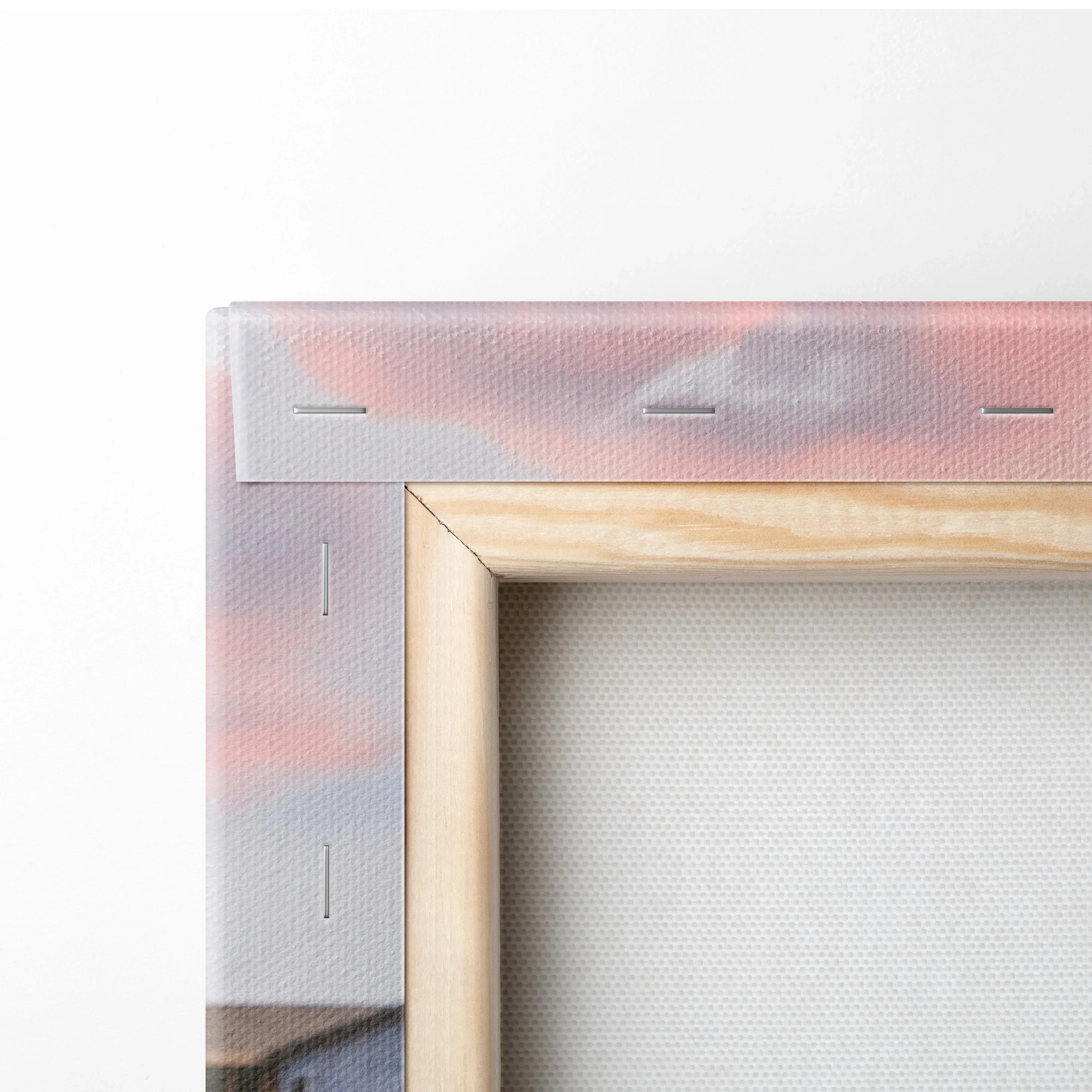 Close-up of wooden frame corner with stapled edge and printed canvas for wall art and canvas art display.