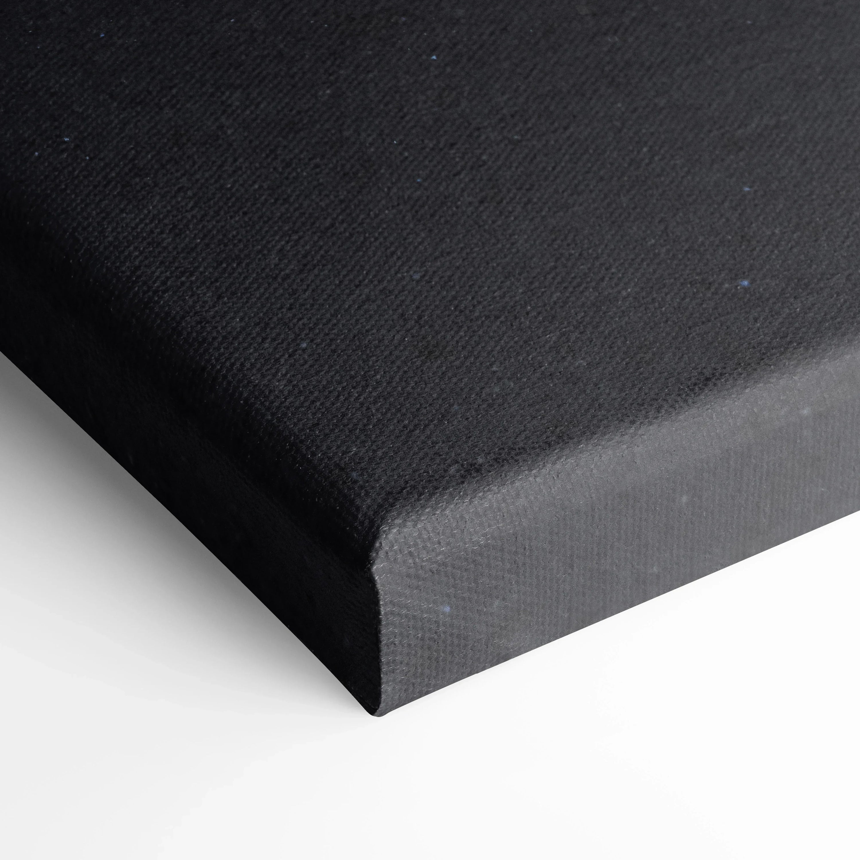 Close-up of black canvas wrap edge showcasing texture and sharp corner of vertical wall art canvas print.