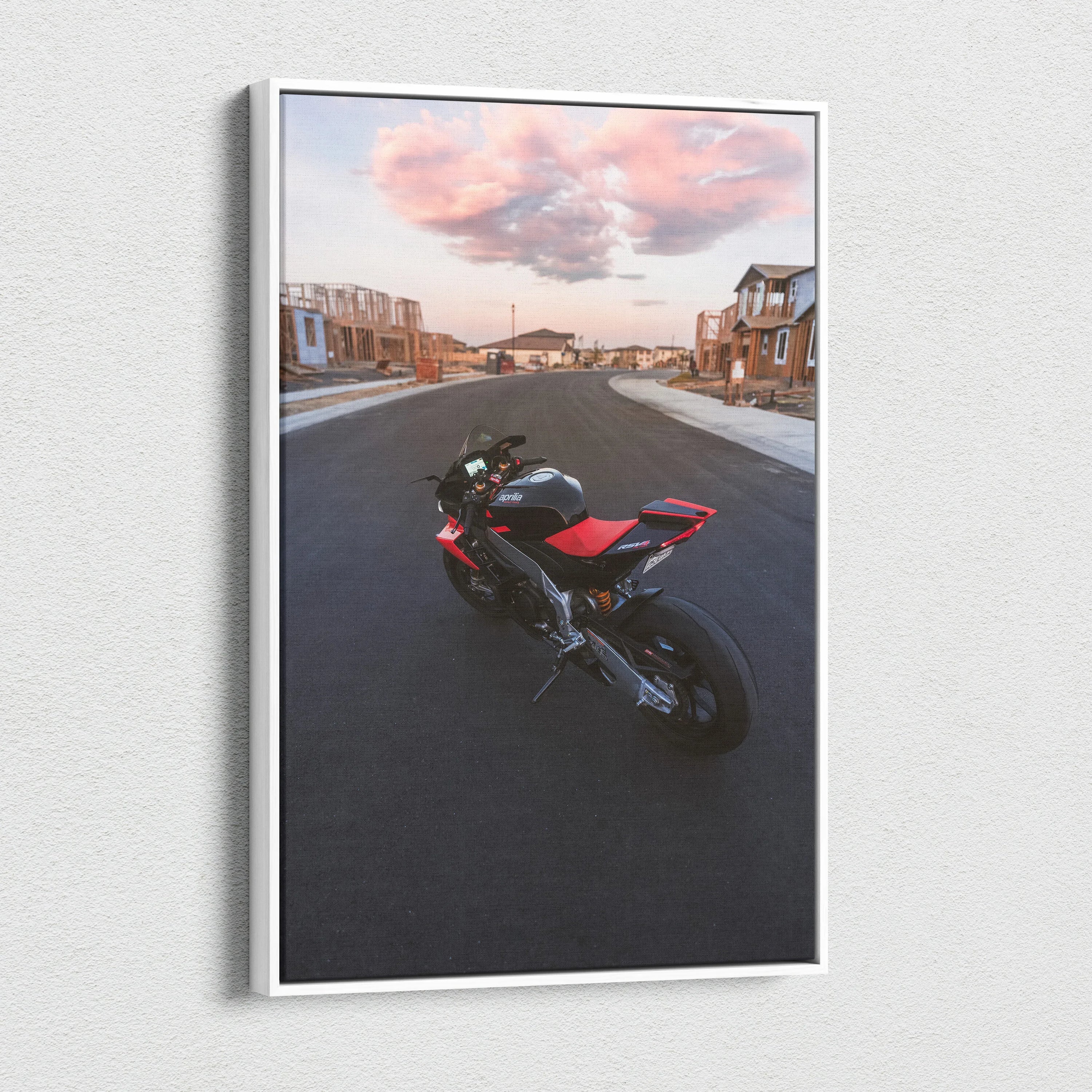 Aprilia RSV4 1100 Factory motorcycle on road under pink sky vertical canvas wall art.