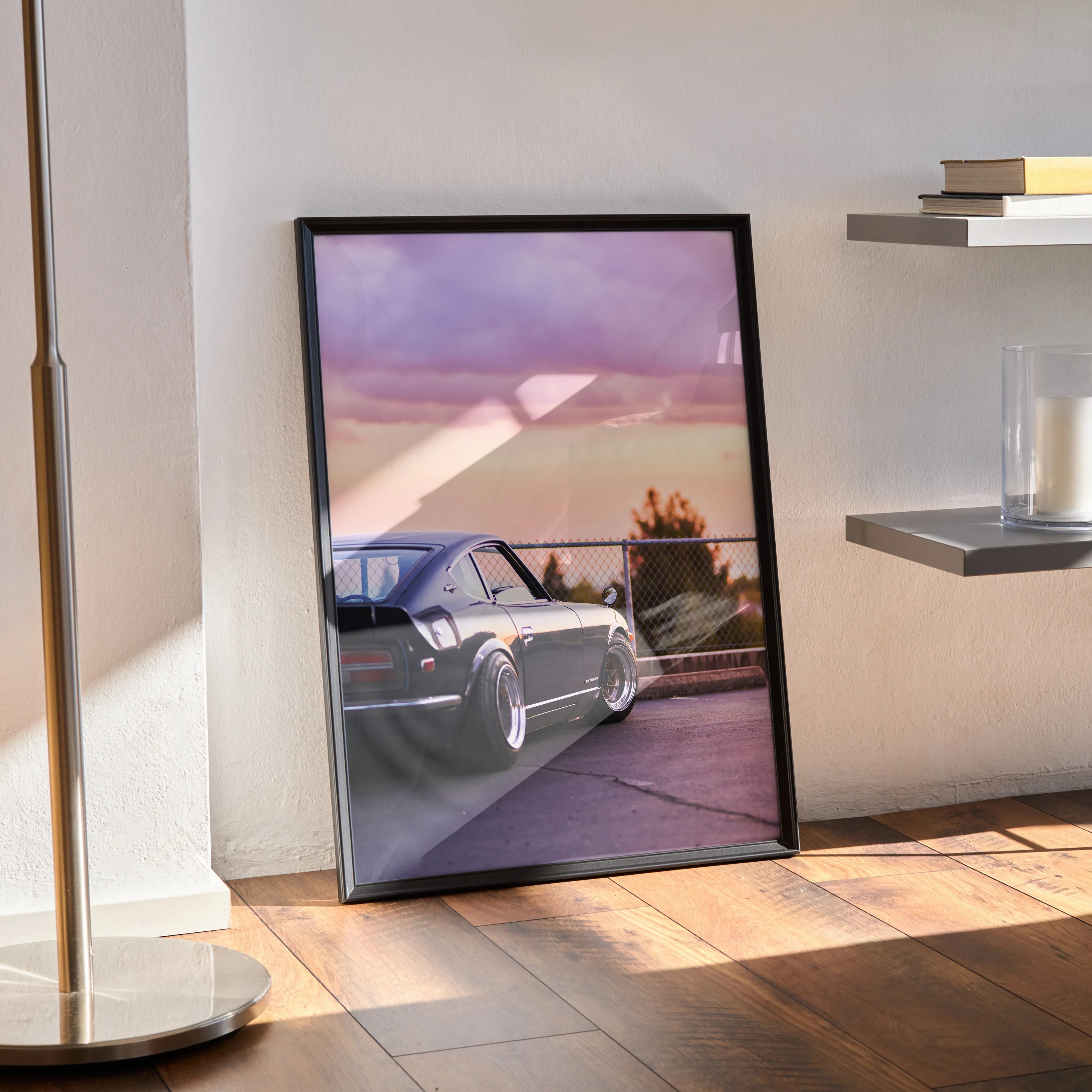 Nissan 240z poster with sleek silver car driving at sunset, modern wall art in black frame.