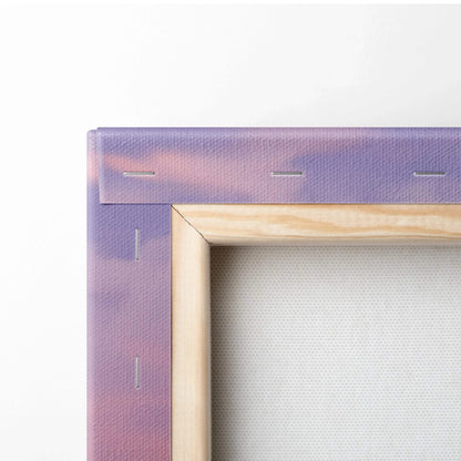 Close-up of unfinished wooden frame corner with purple-stained canvas stretched and stapled on back for wall art canvas print.