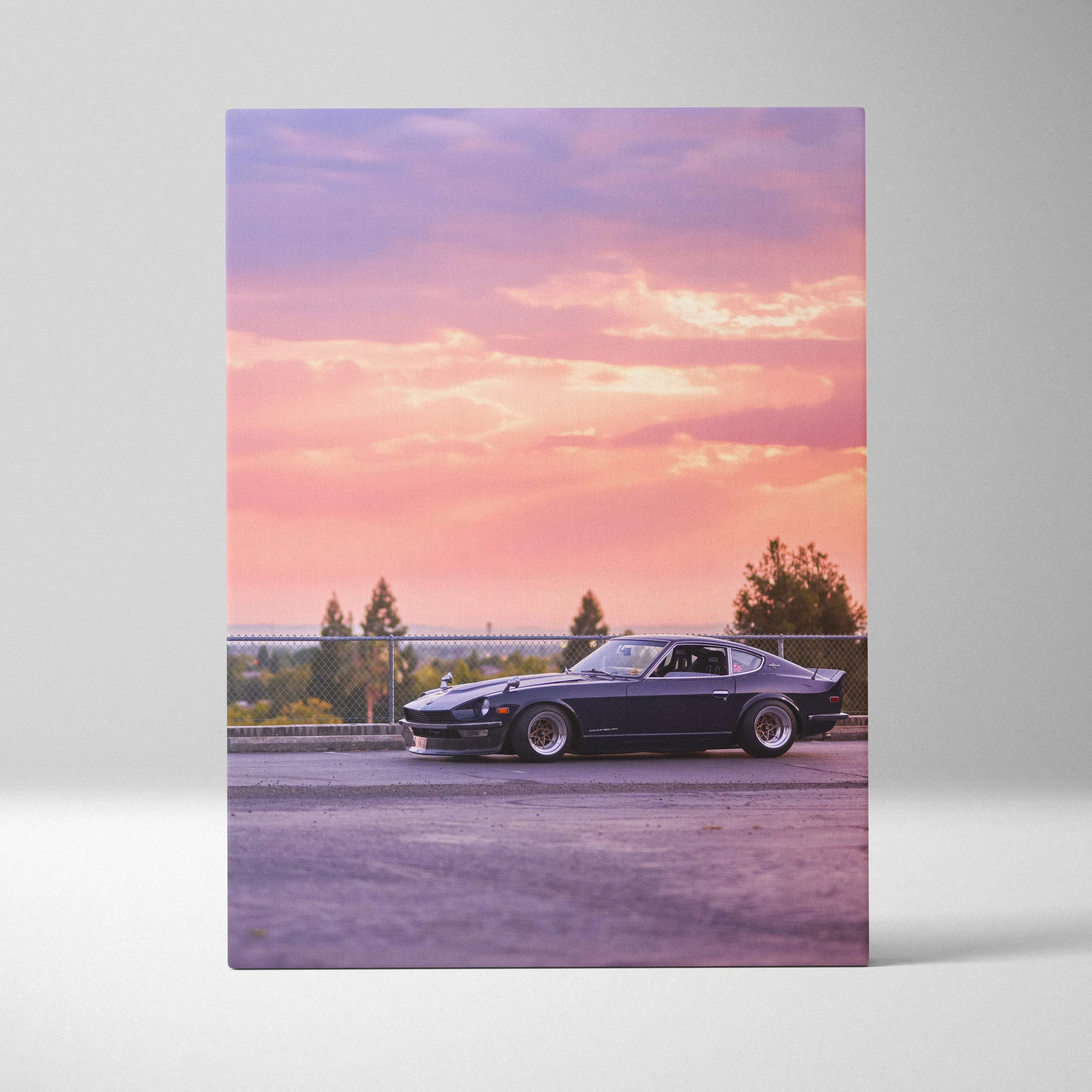 Nissan 240z parked at sunset landscape canvas wall art with pink and purple sky.