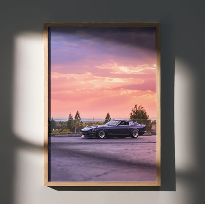 Nissan 240z poster wall art with car at sunset framed in wood, vibrant pink and purple sky.