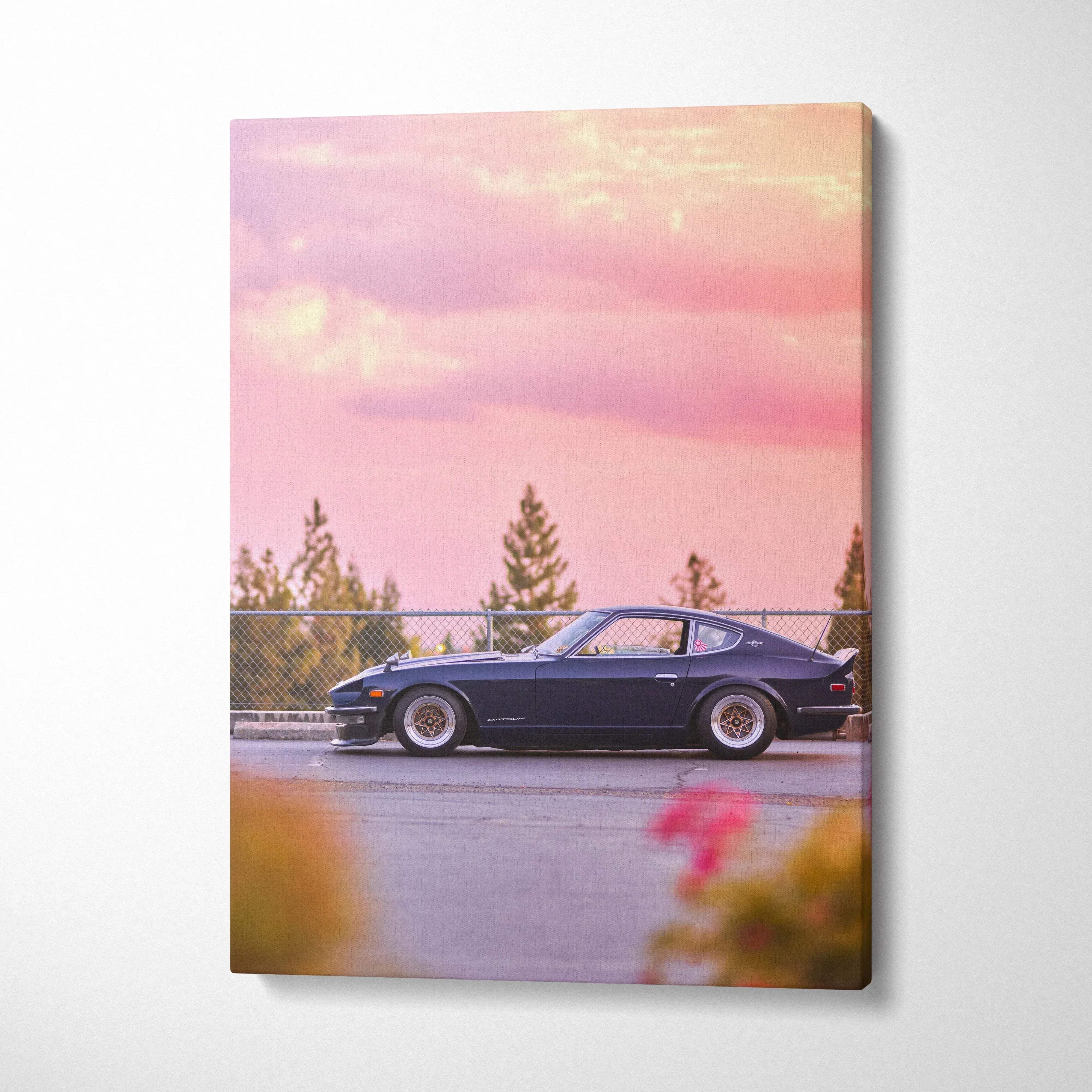 Nissan 240z sleek black car at sunset with pink sky on vertical canvas wall art.