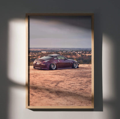 Nissan 350z poster wall art with purple sports car in desert landscape at sunset.