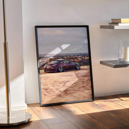 Nissan 350z poster wall art with sleek purple sports car on a desert road in black frame.