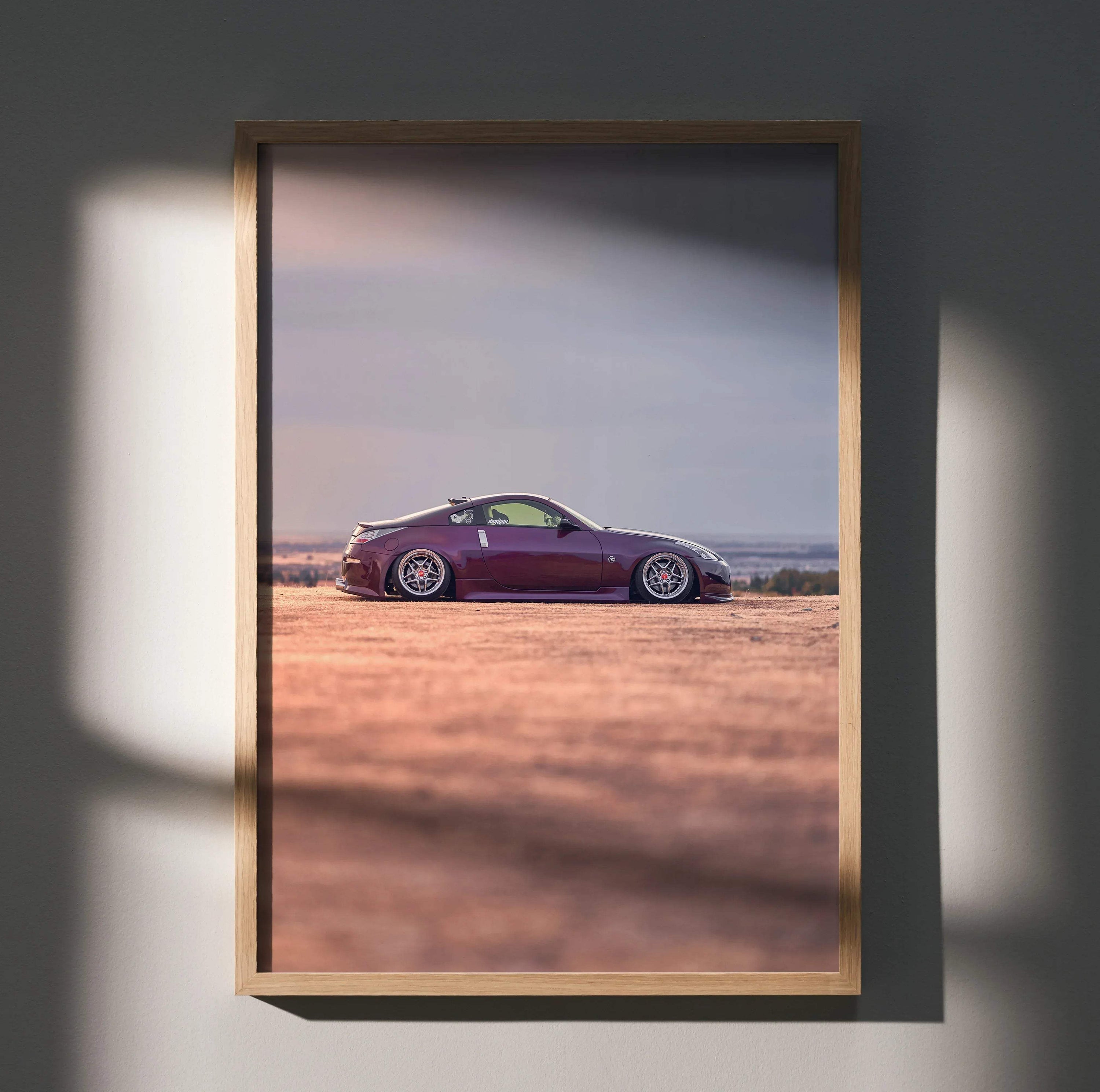 Nissan 350z in purple parked on open terrain at sunset poster wall art in wooden frame.
