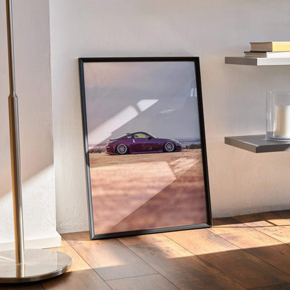 Nissan 350z poster with sleek purple car against desert wall art in black frame.