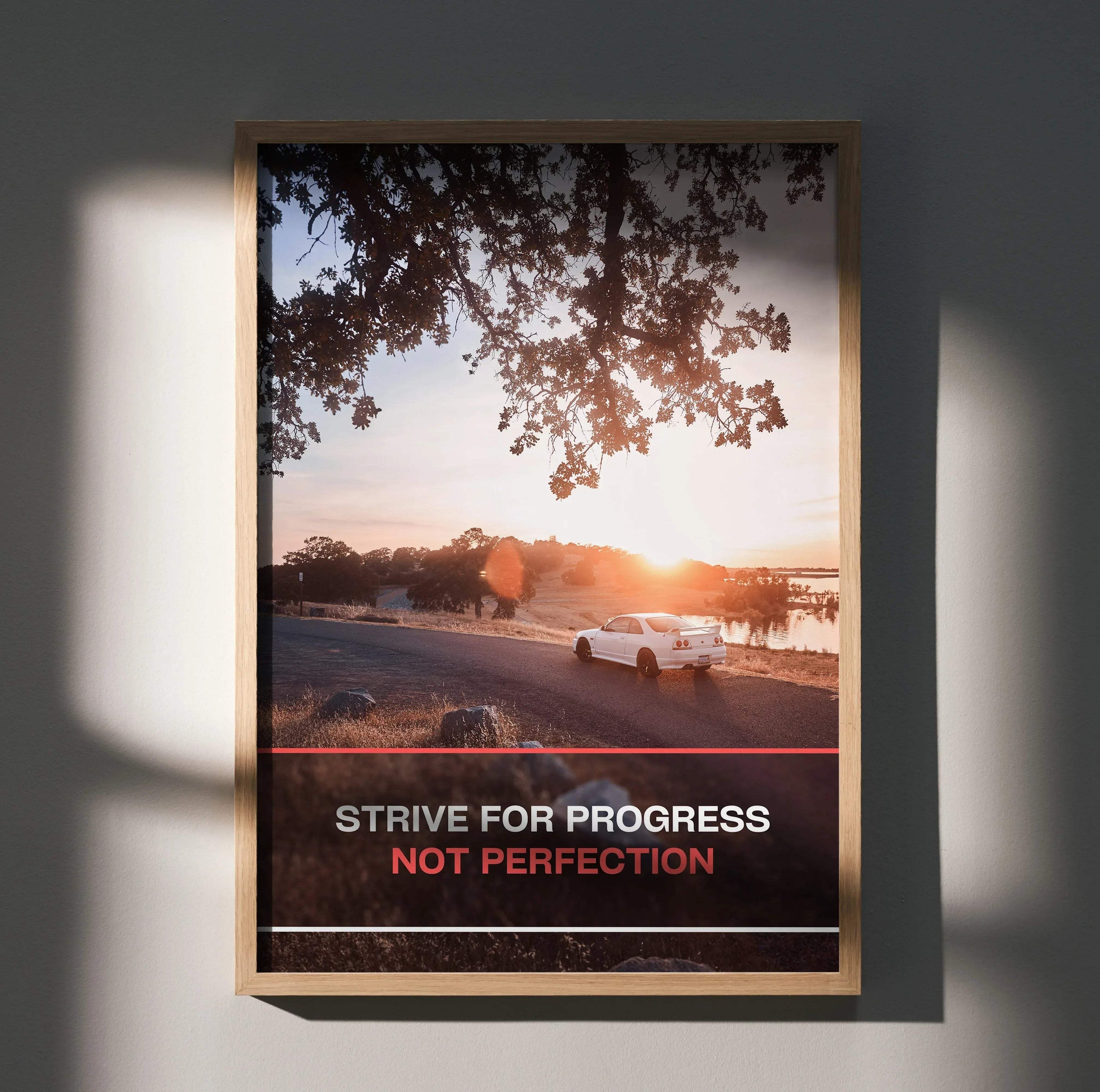 Motivational poster wall art with Nissan R33 Skyline GTS-T by sunset and text "Strive for progress not perfection".