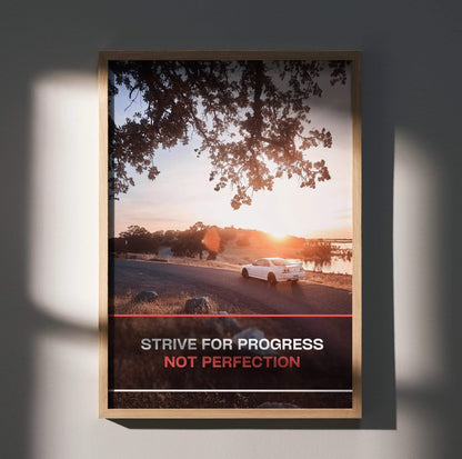 Motivational poster wall art with Nissan R33 Skyline GTS-T by sunset and text "Strive for progress not perfection".