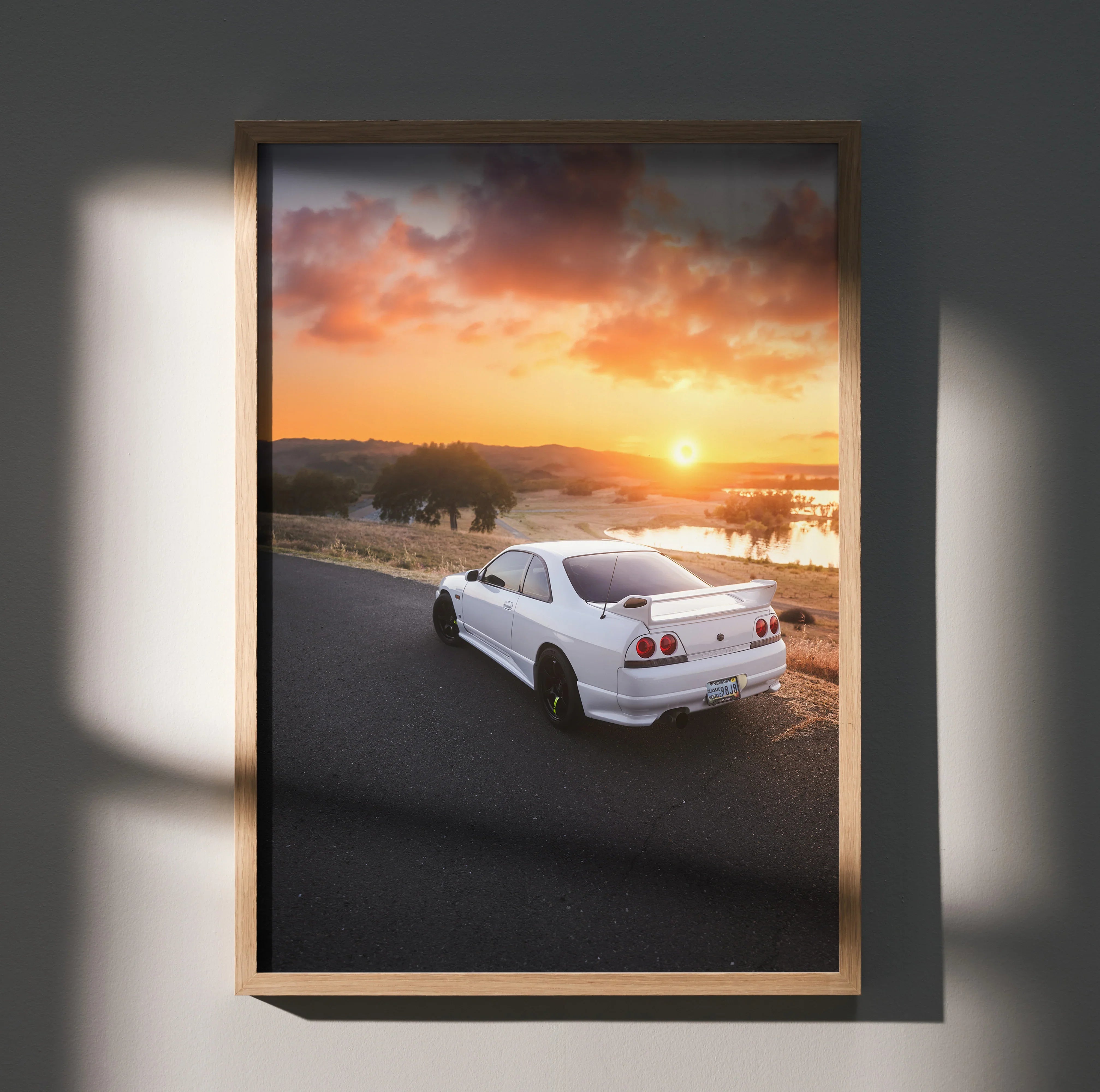 Nissan Skyline R33 GTS-T poster showing white sports car on coastal road at sunset, premium wall art.